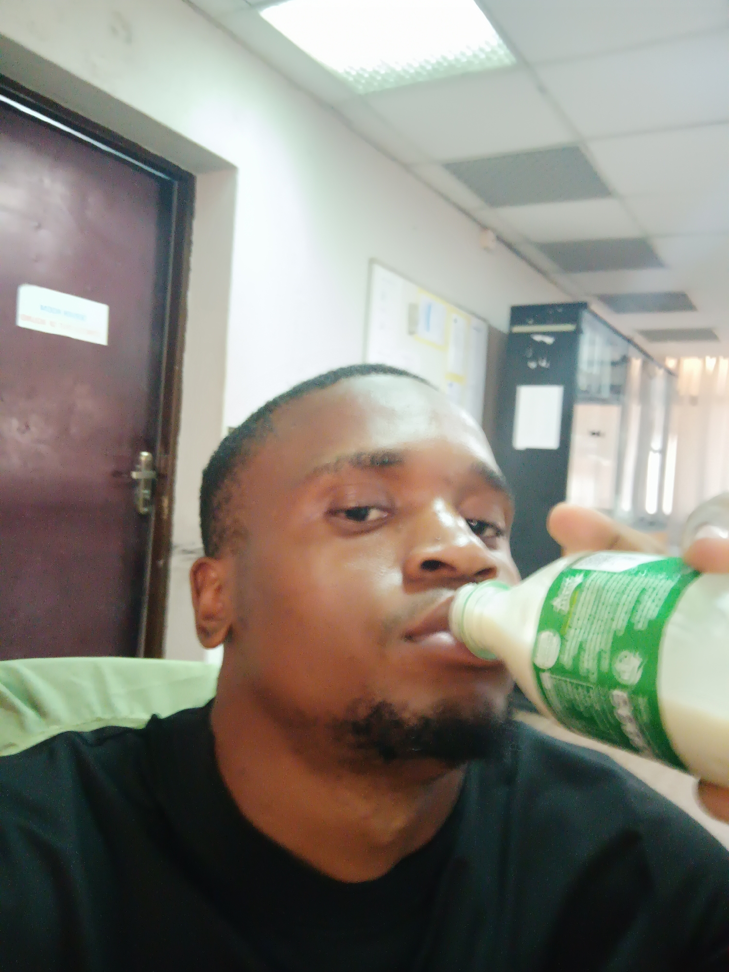 Man photographed drinking, taking selfies in Nigerian office spaces