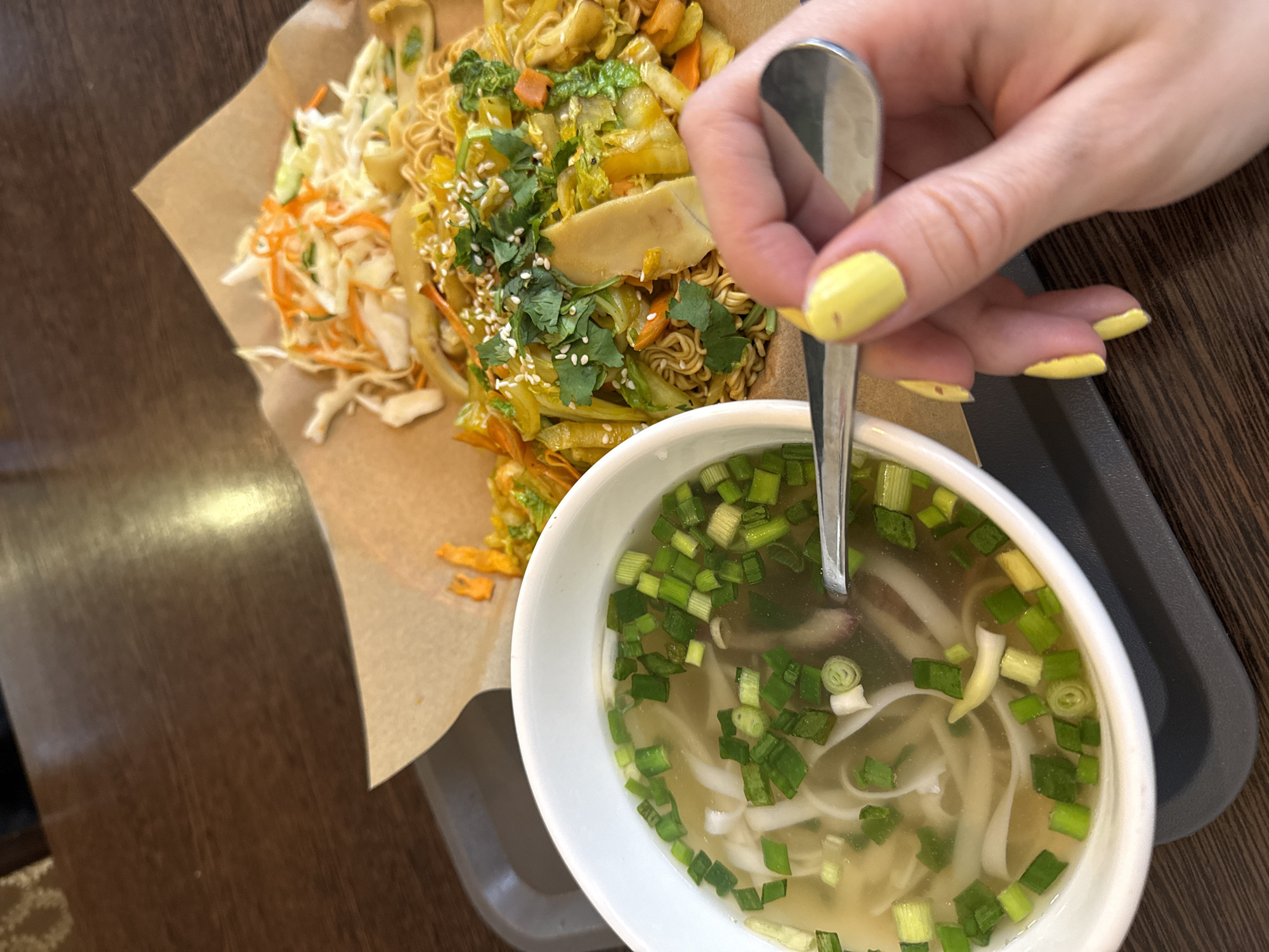 Person enjoys Vietnamese pho soup in Moscow