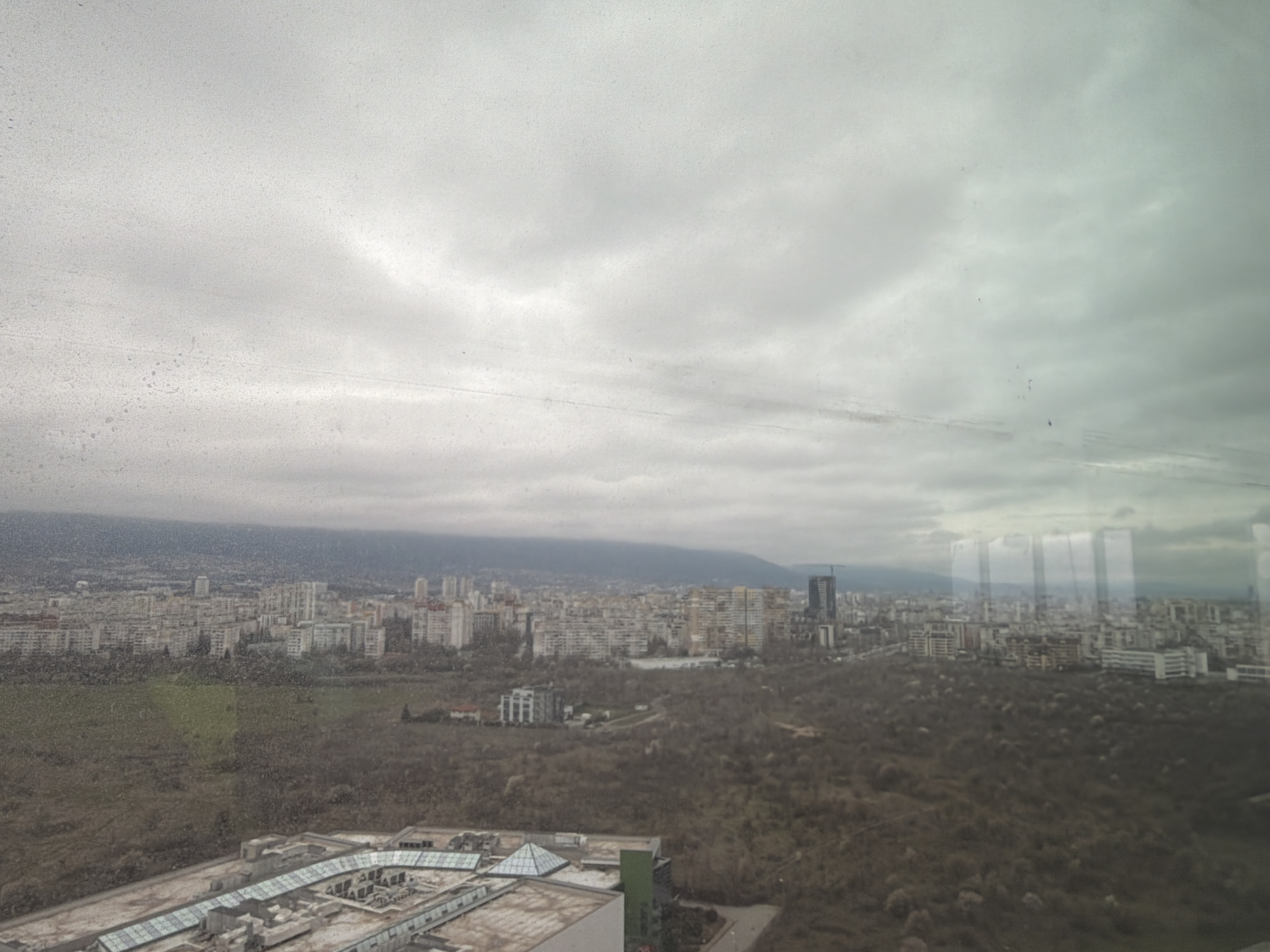 Sofia cityscape photographed from elevated viewpoint under overcast skies