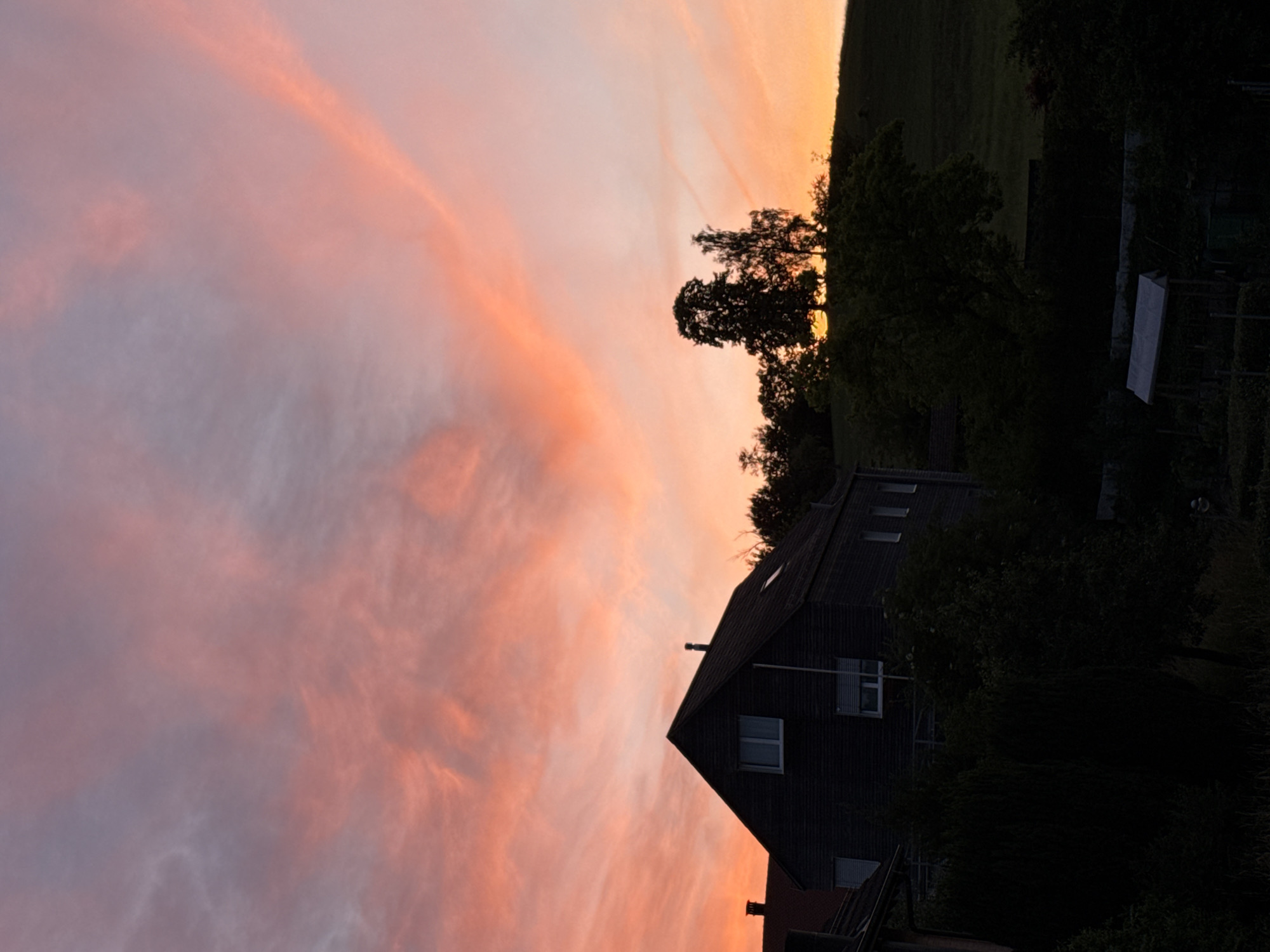 Sunset colors paint the sky over Lufingen, Switzerland