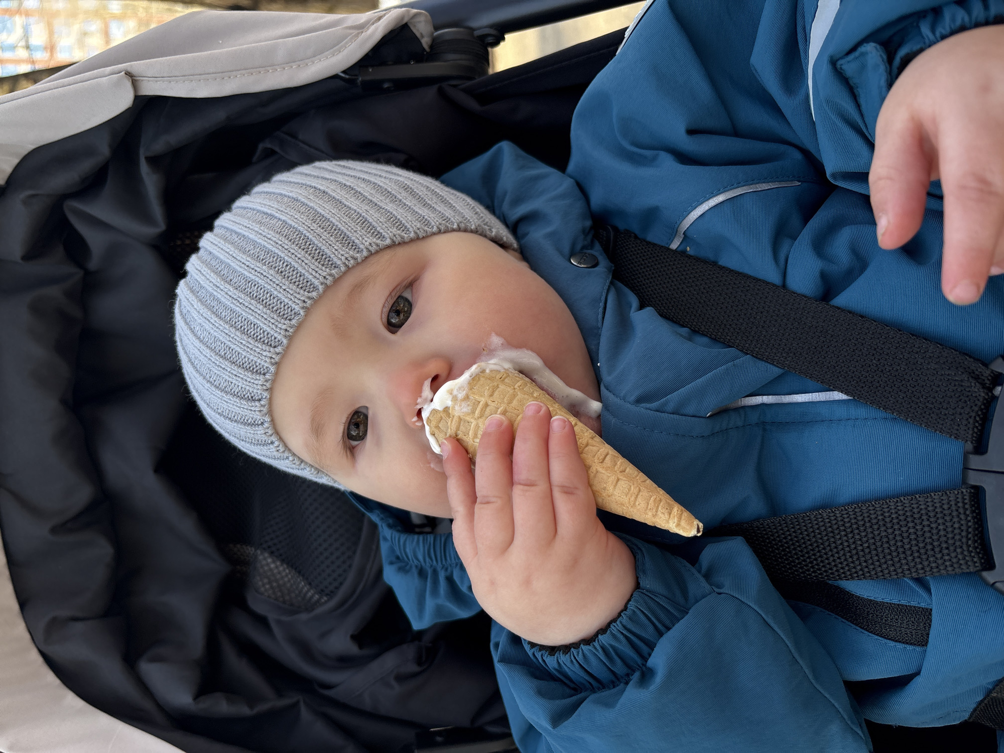 Child enjoys ice cream in stroller in Izhevsk