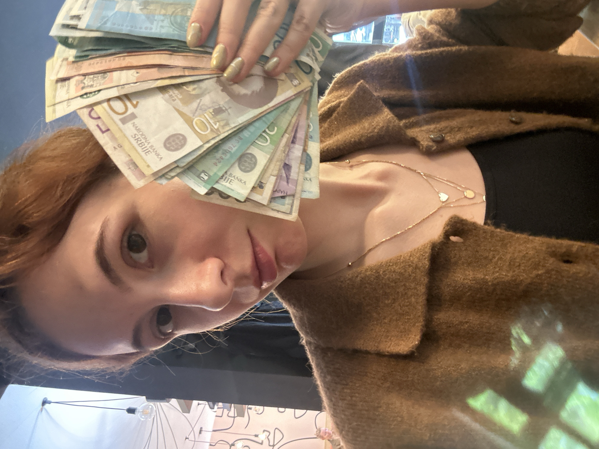Woman displays cash, uses crypto app in Novi Sad
