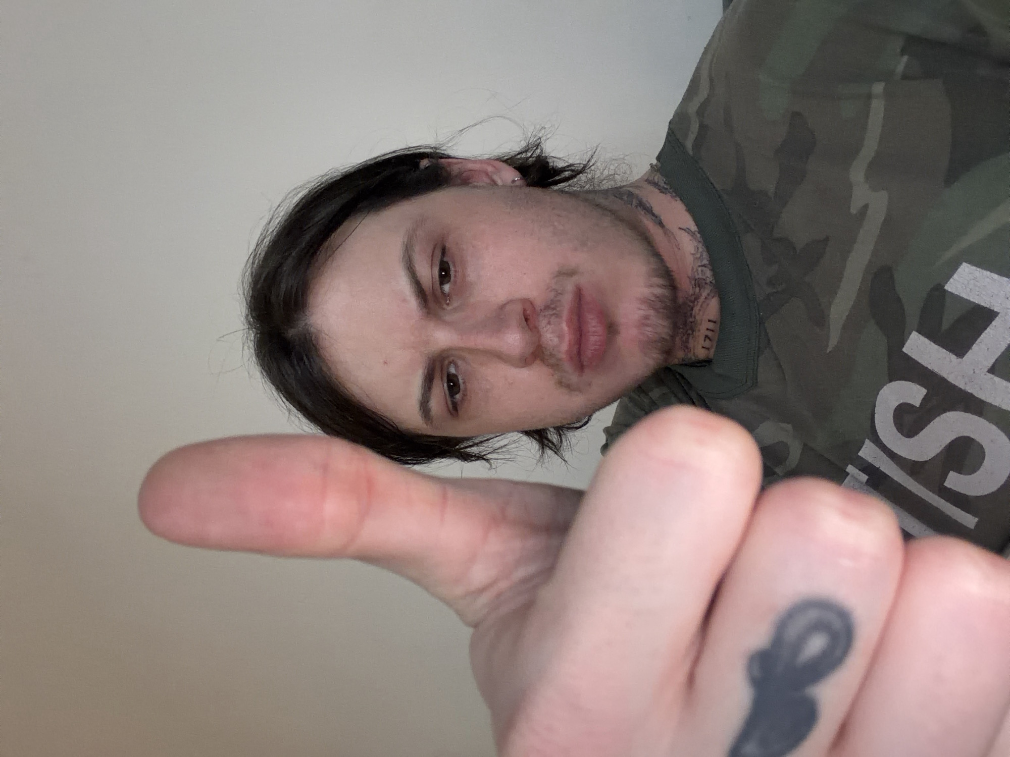 Person gives thumbs-up gesture in London