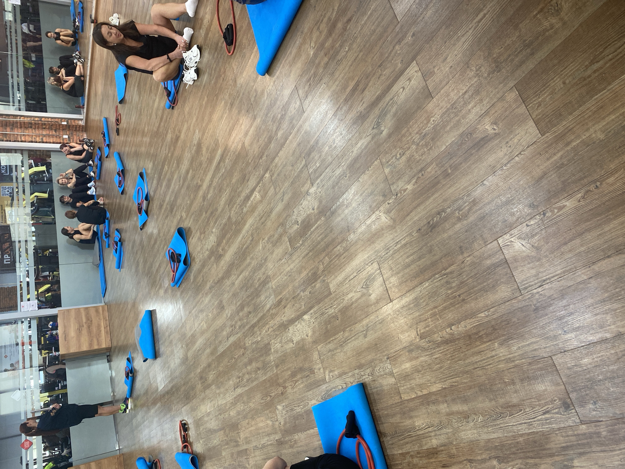 Women participate in fitness class at indoor gym