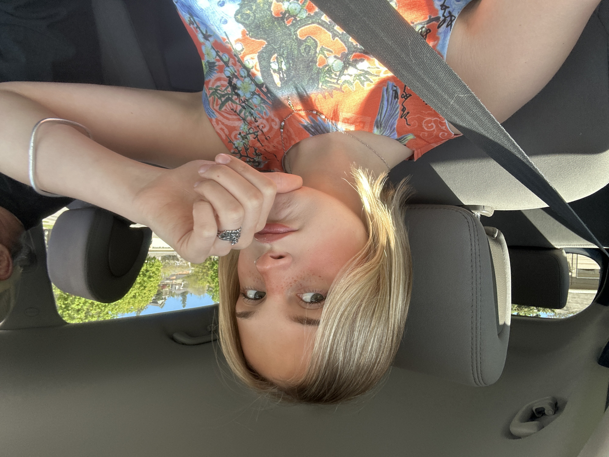 Woman takes selfie in passenger seat, Kelowna