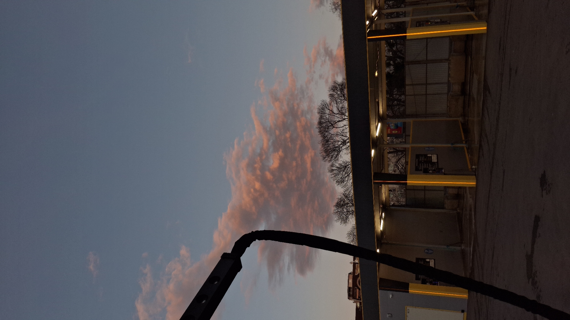 Outdoor carwash photographed at dusk with colorful evening sky