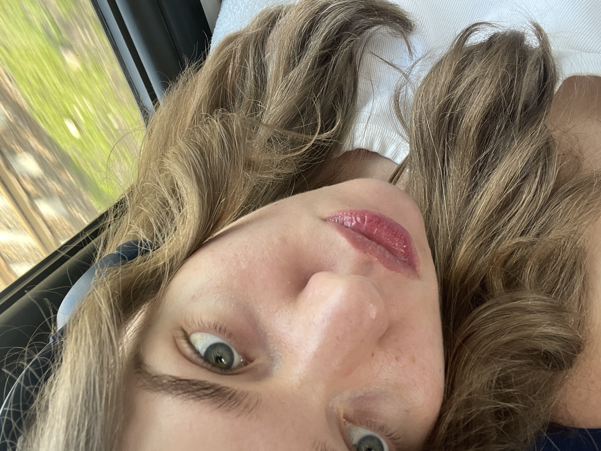 Woman takes selfie indoors in Moscow with nature backdrop