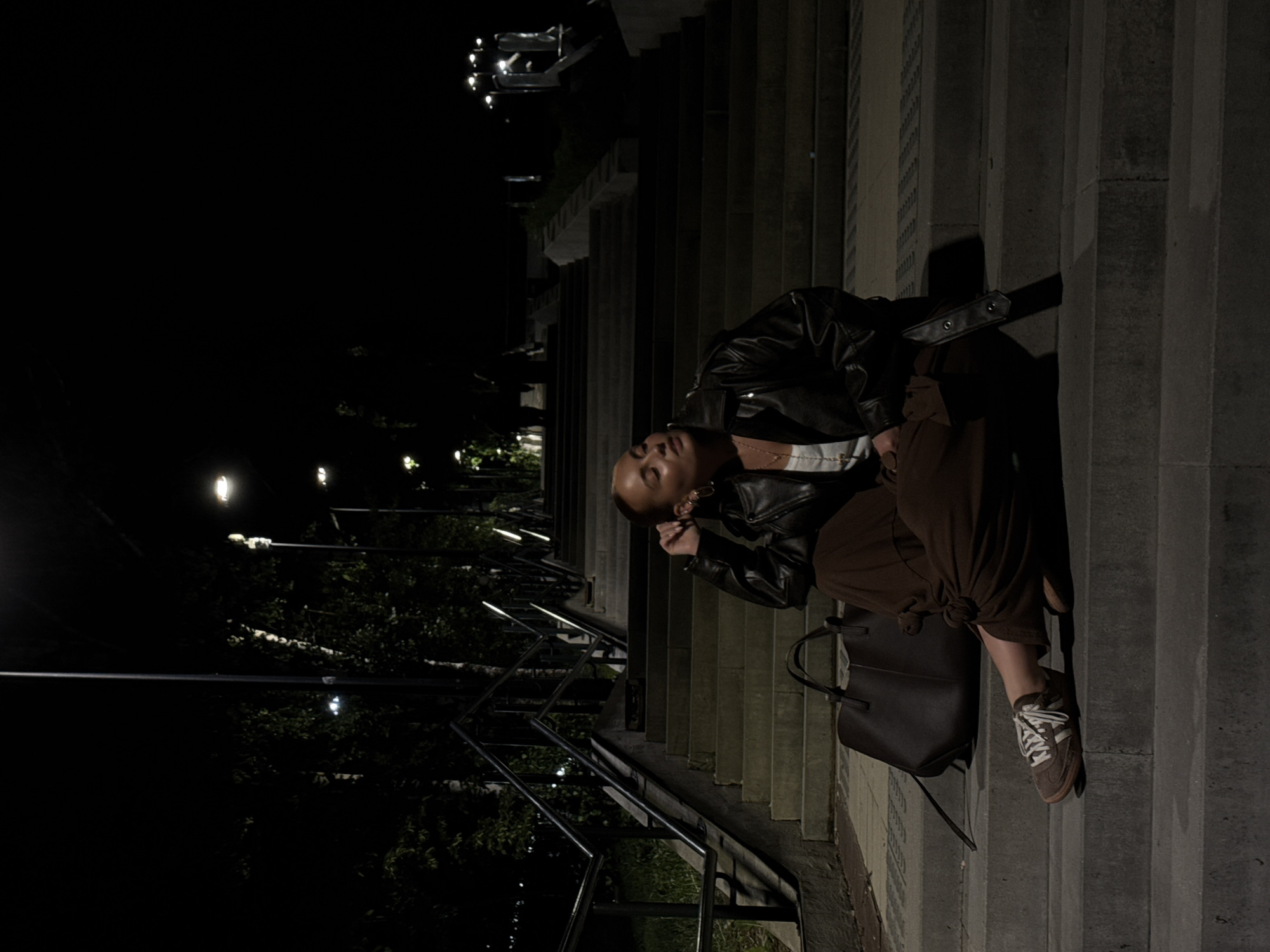 Women gather at illuminated monuments in Izhevsk during evening