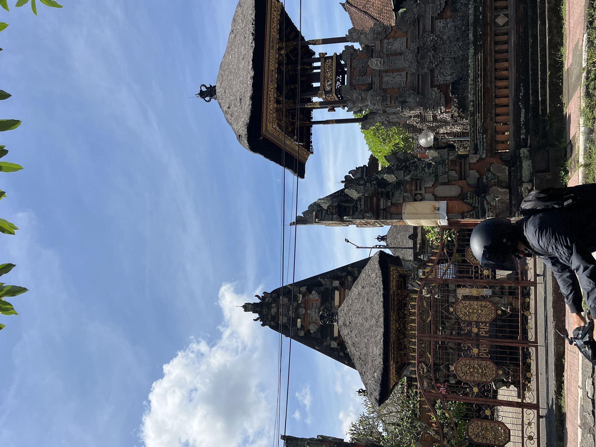 Balinese artisans craft wooden sculptures in predawn Ubud workshop