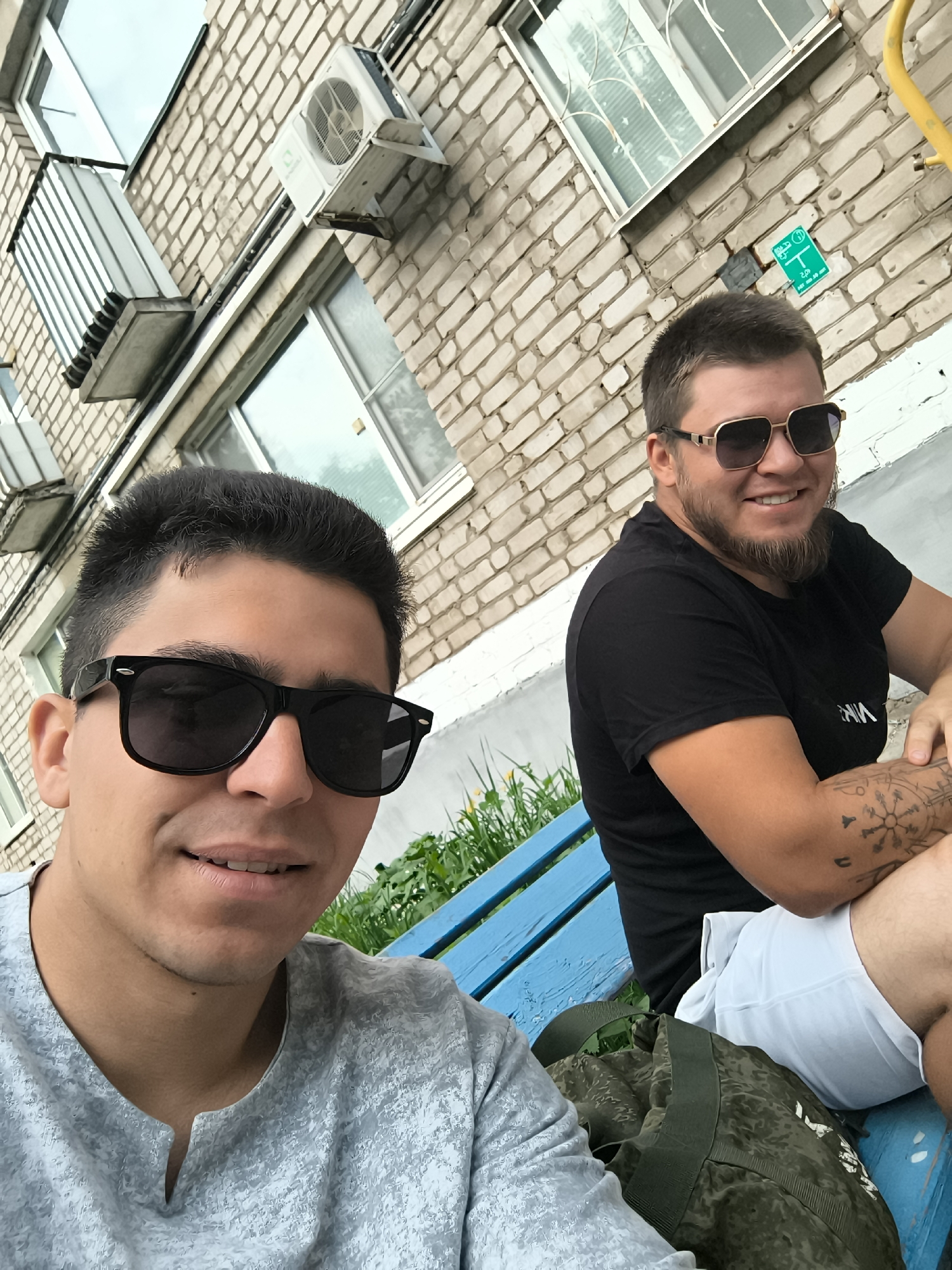 Urban memories captured: men on bench, sky, selfie, lighter
