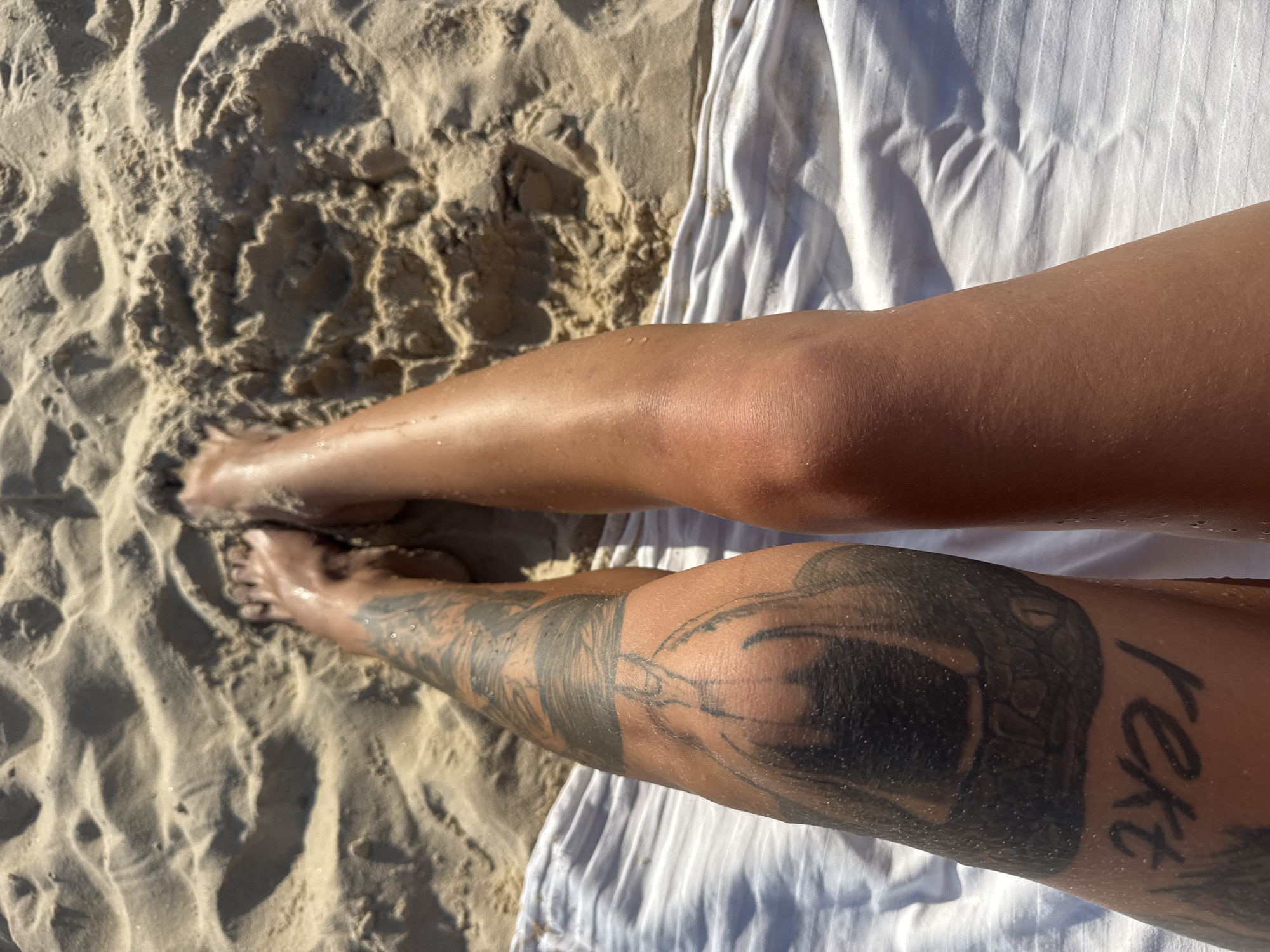 Beach day with surfers, warning flags, and nearby construction