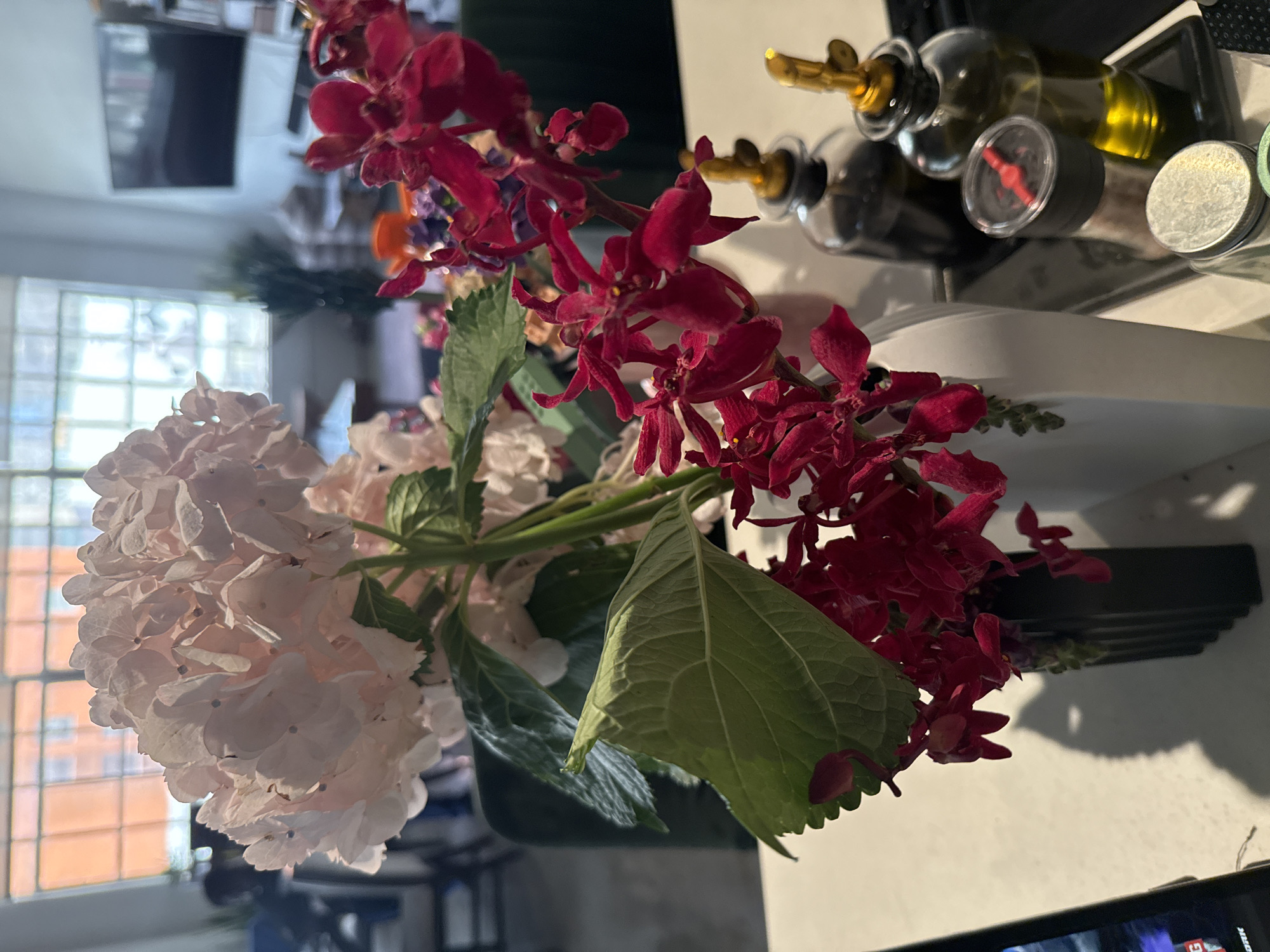 Pink hydrangeas and red orchids arranged in Los Angeles bouquet