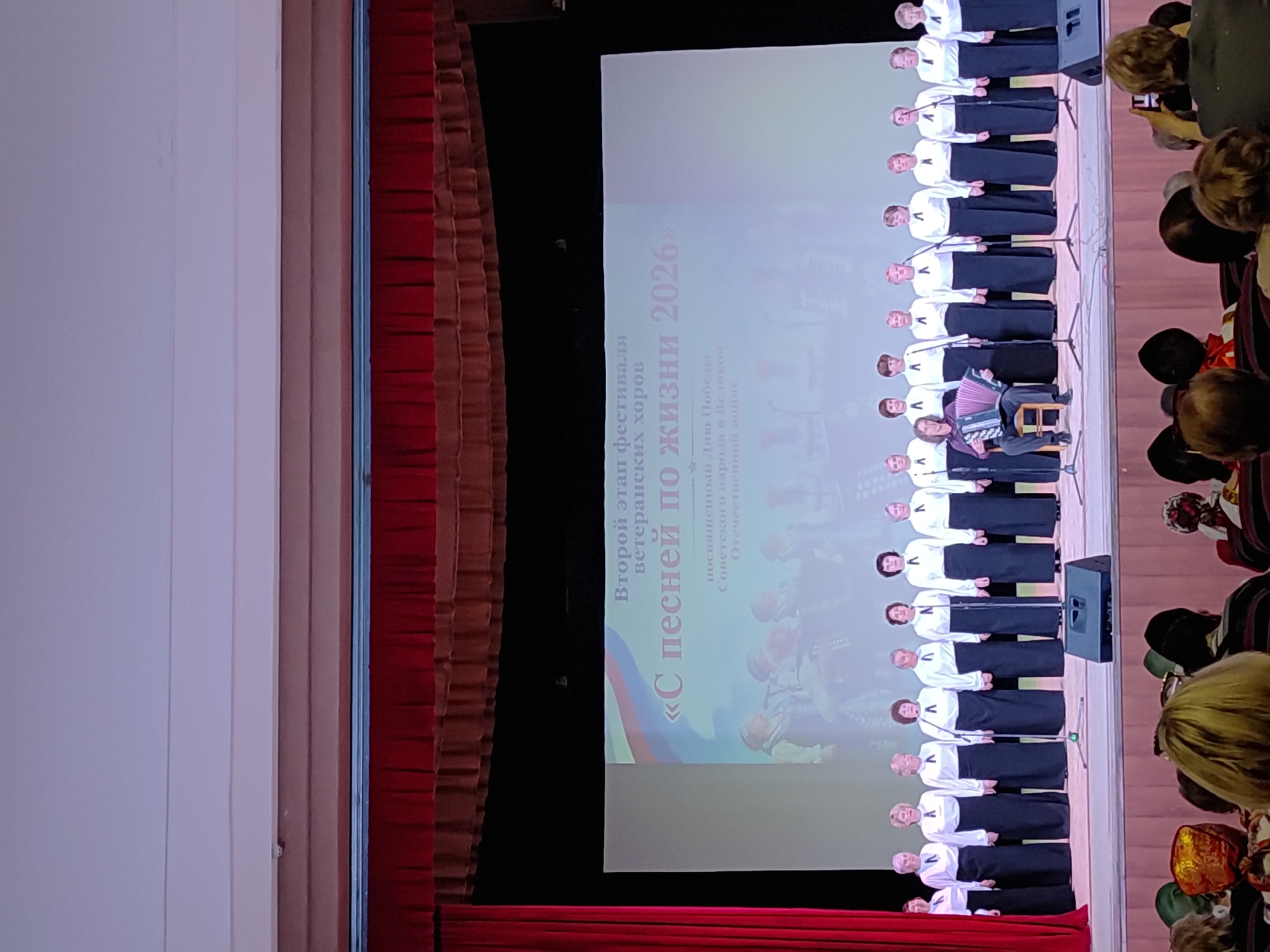 Elderly women's folk choir performs with accordion accompanist