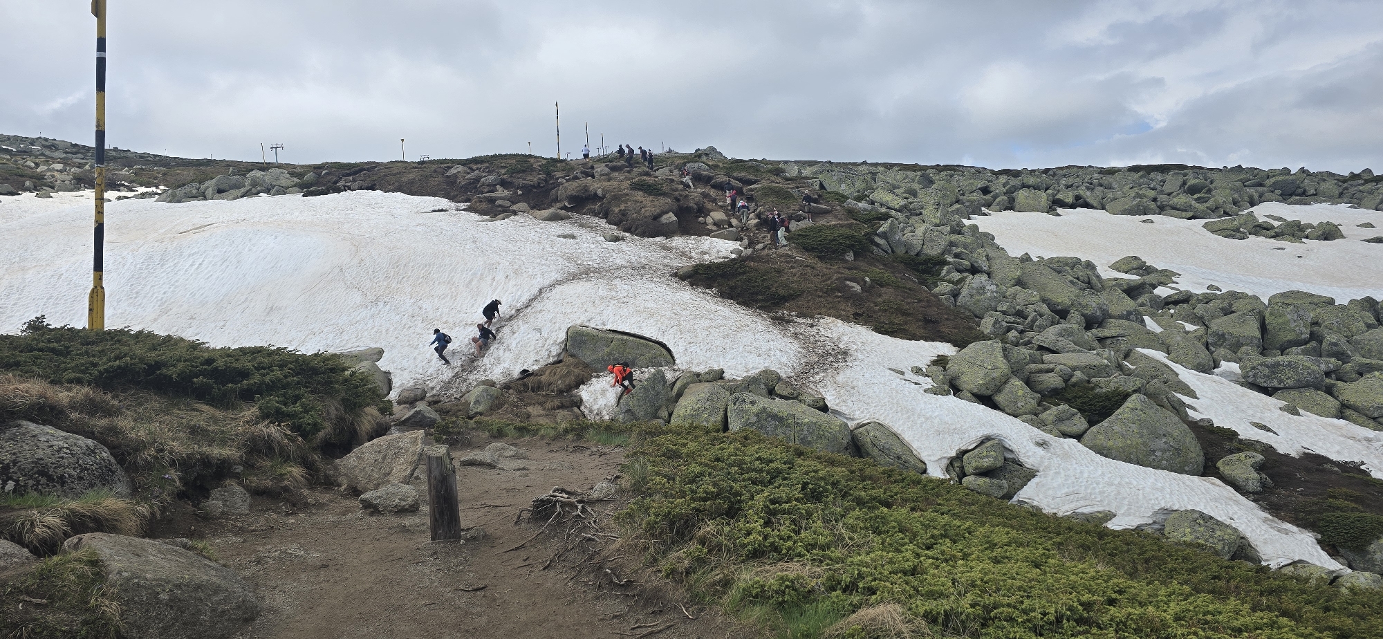 Hikers traverse snowy mountain terrain near Bistritsa, Bulgaria