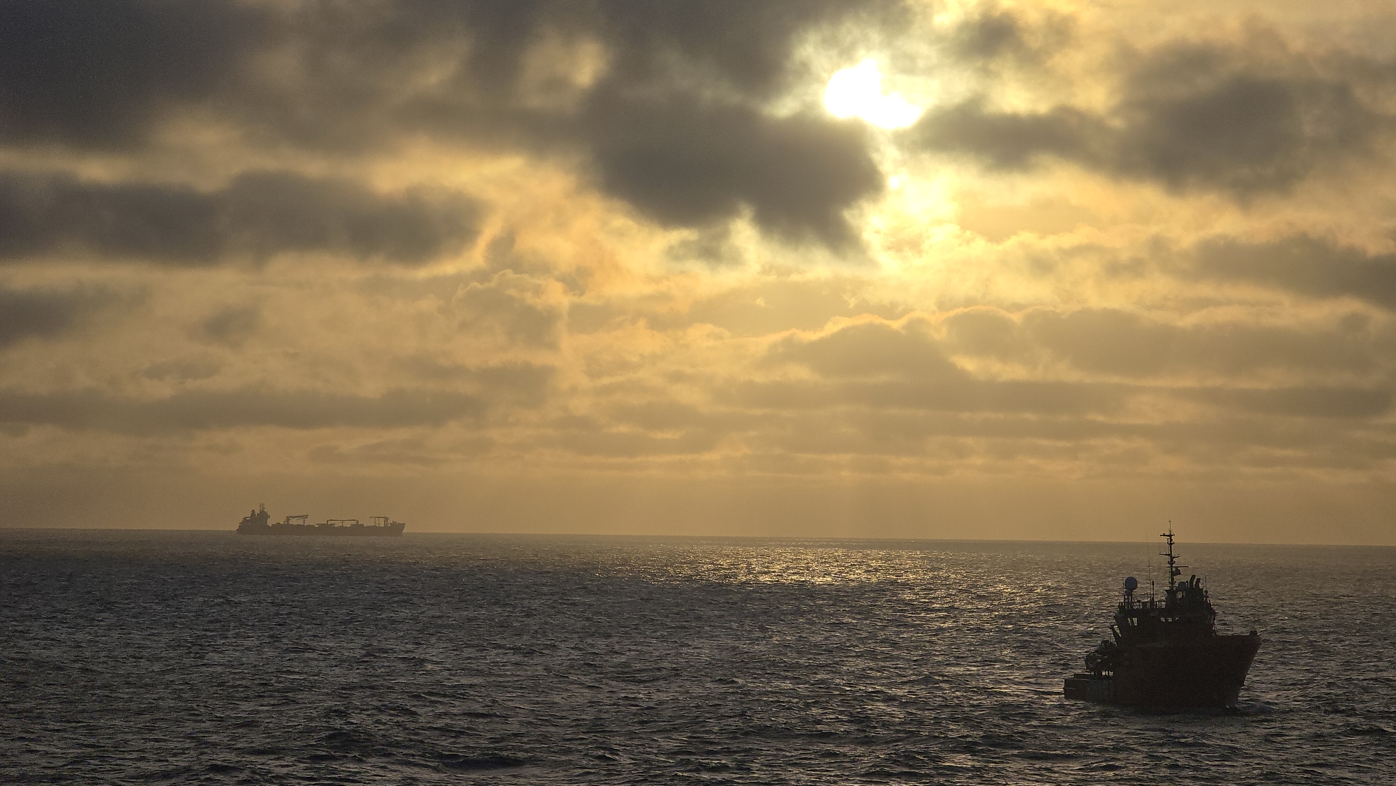 Ships spotted off Norway coast during golden sunrise