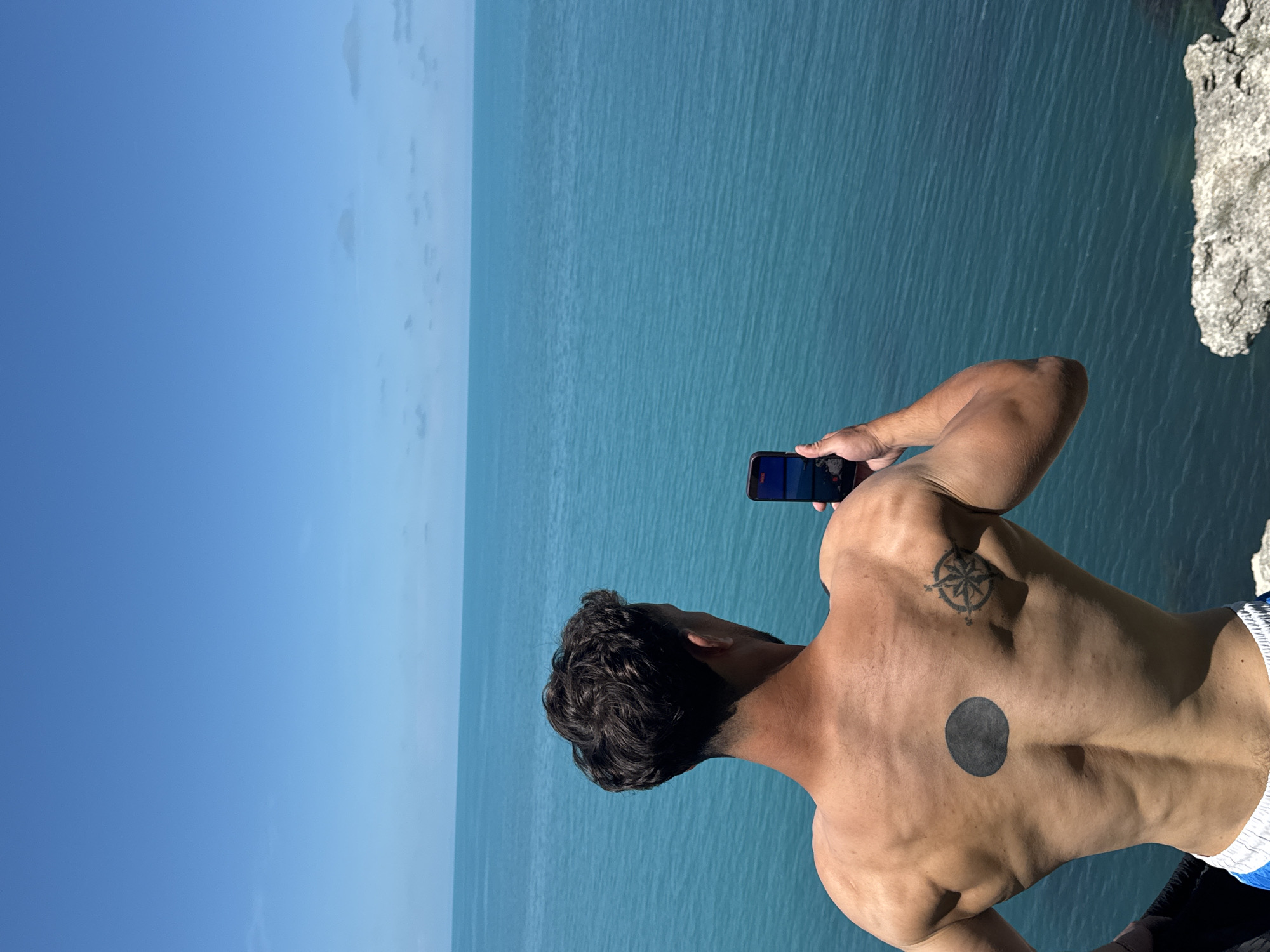 Young men exercise at clifftop gym overlooking Black Sea