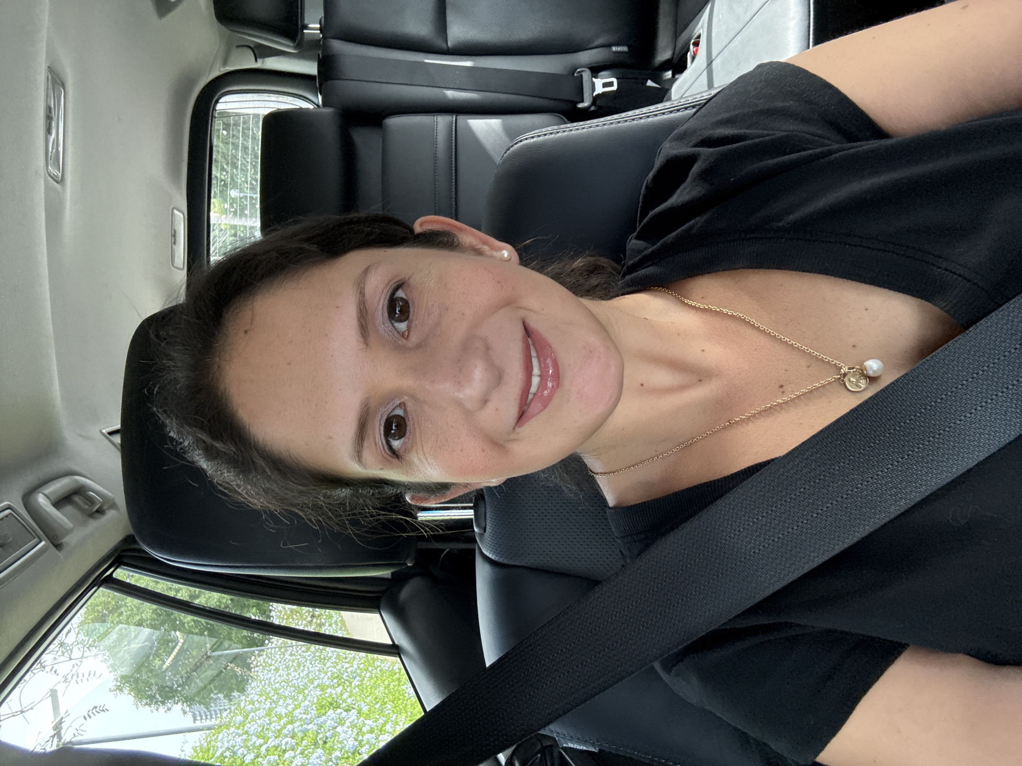 Woman photographed smiling in driver's seat in San Isidro