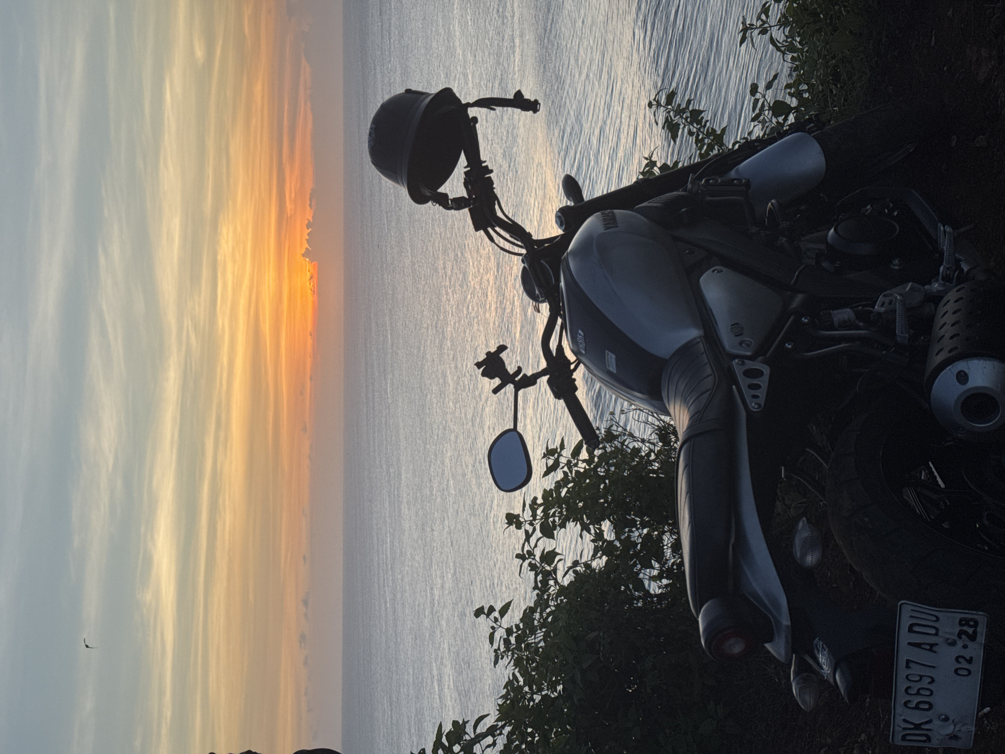 Motorcycle sunset ride documented along coastal cliffs and scenic roads