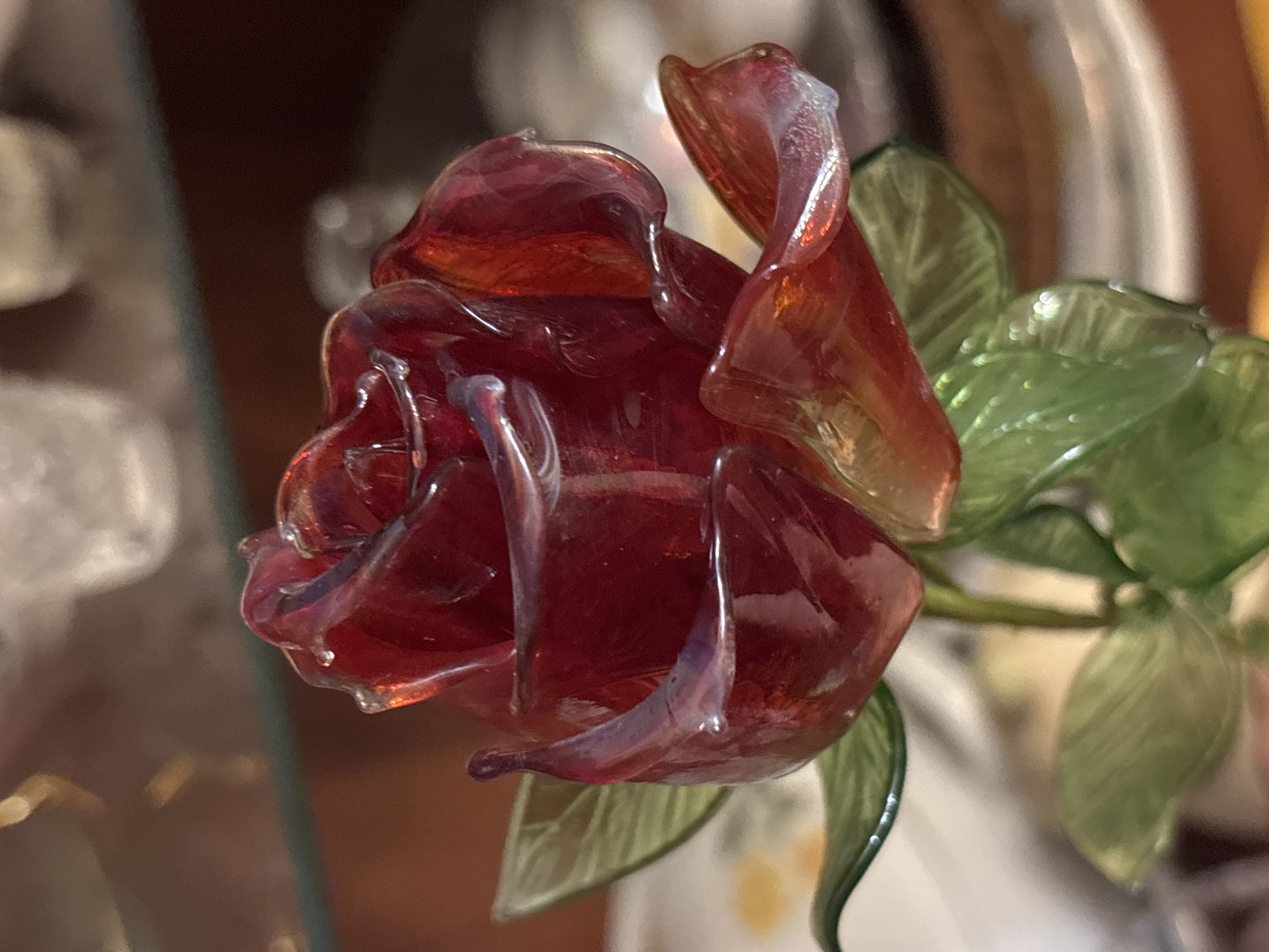 Glass rose, crocheted doily, and church miniature up close