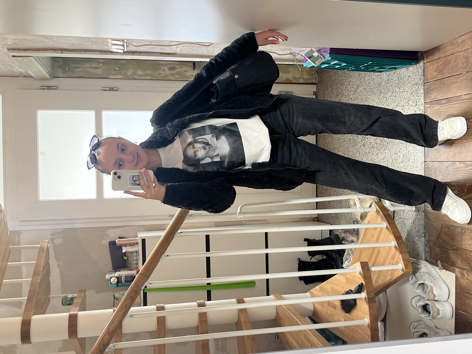 Woman takes selfies indoors in Saarbrücken apartment