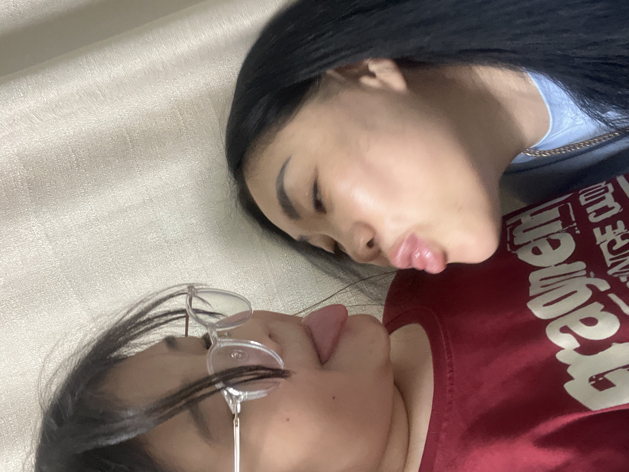 Two people share playful moment lying together