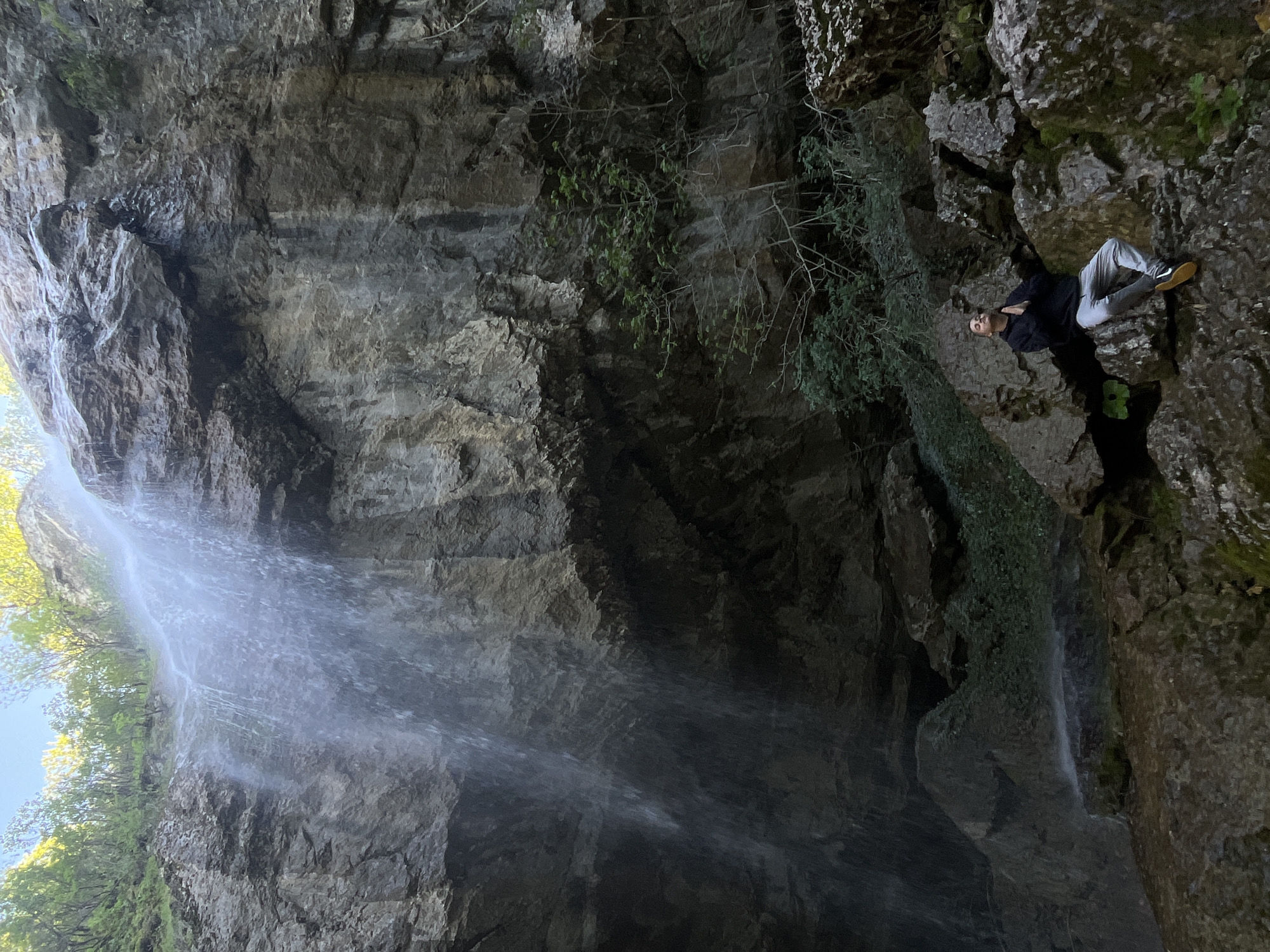 Visitors explore waterfall and caves near Veselinovo, Bulgaria