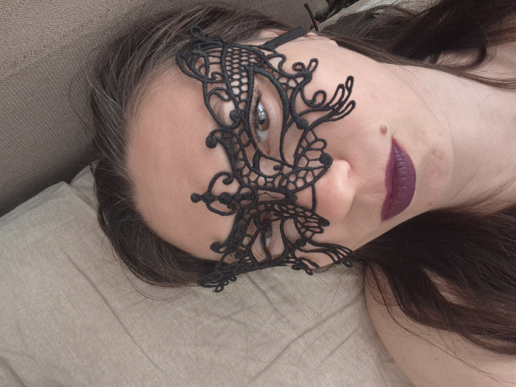 Woman photographed in intimate indoor portrait session with accessories