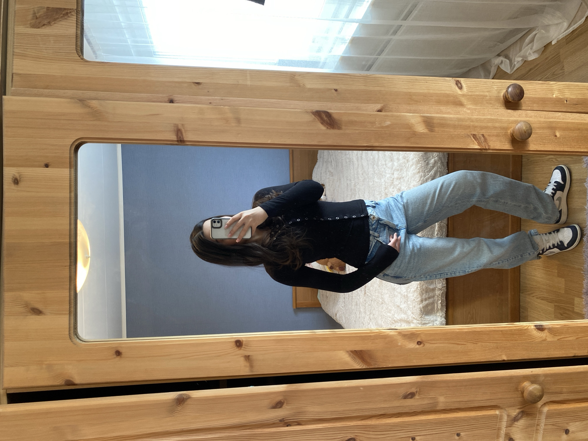Woman takes mirror selfie in Björklinge home