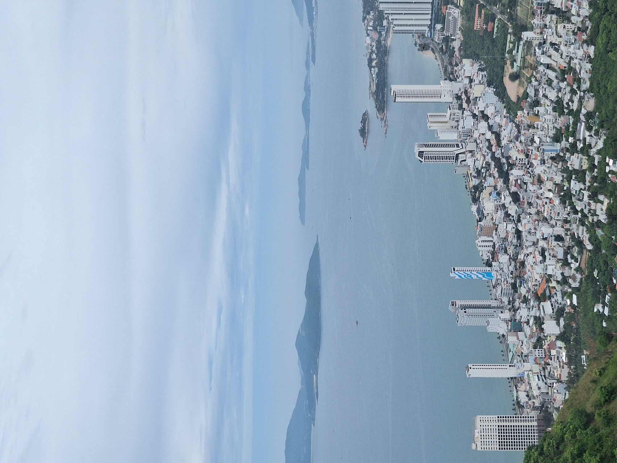 Hilltop panoramas over Nha Trang's coastal cityscape on an overcast morning