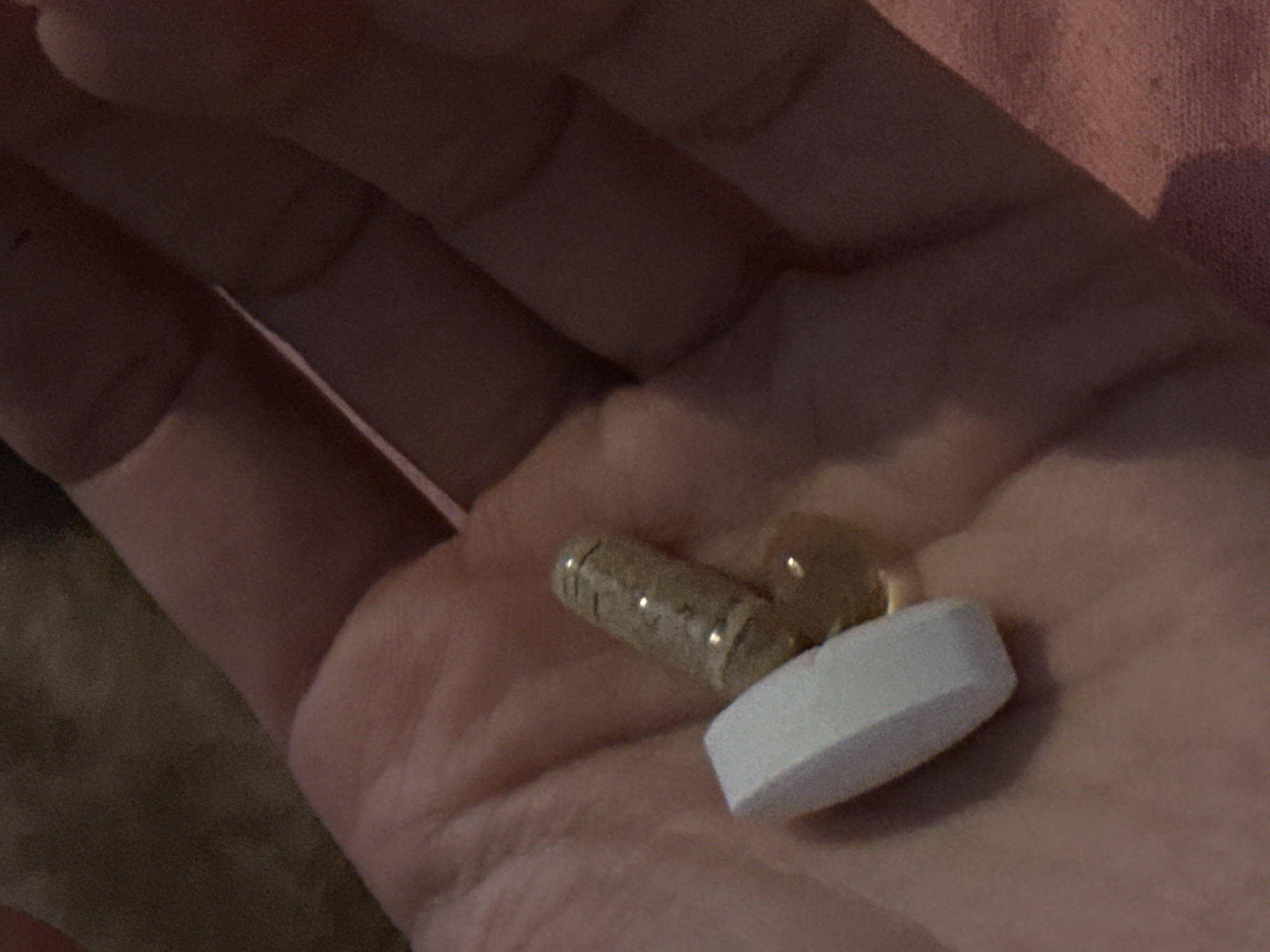 Person holds two different pills in Amsterdam