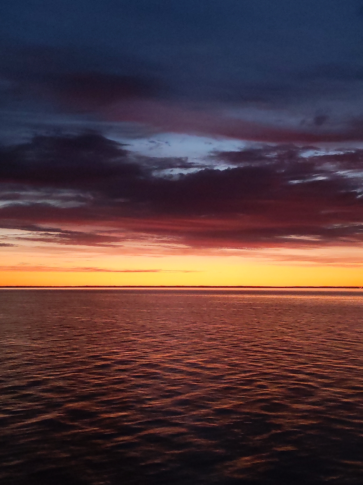 Sunset observed over Russian waters with gradient sky colors