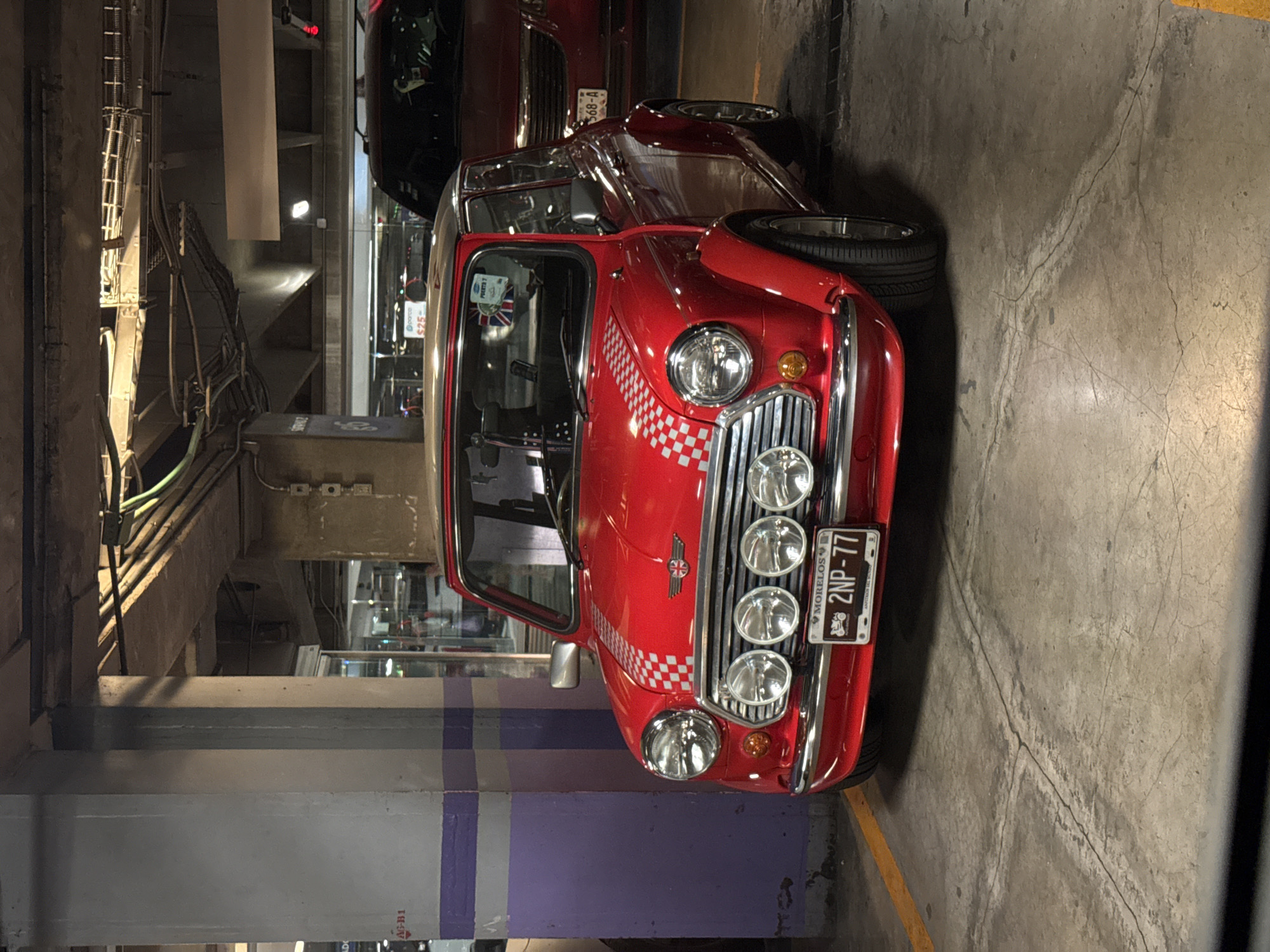 Classic Mini Cooper with checkerboard pattern spotted in Mexico City garage