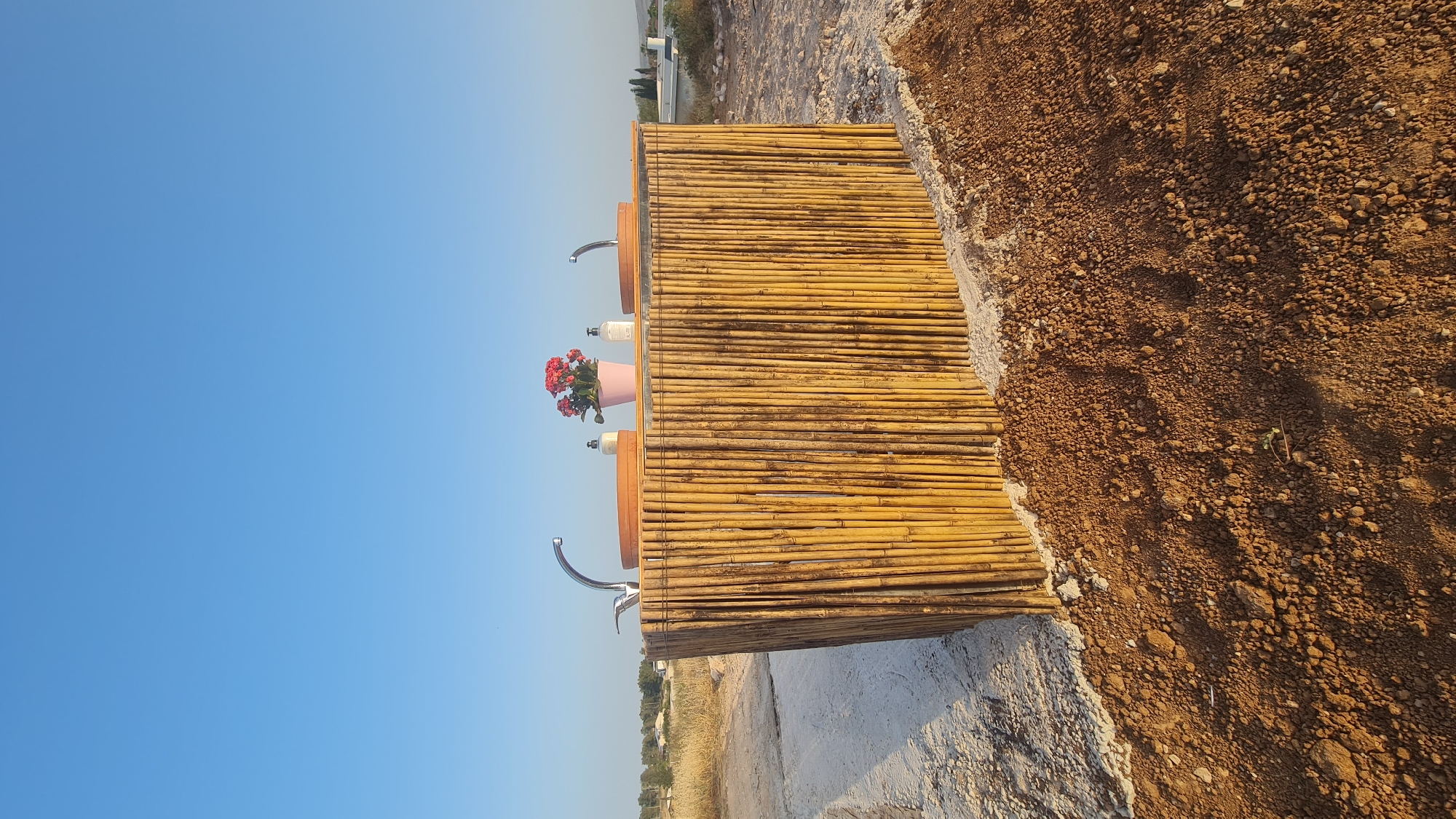 Outdoor bamboo vanity with flowering plants documented in Israel