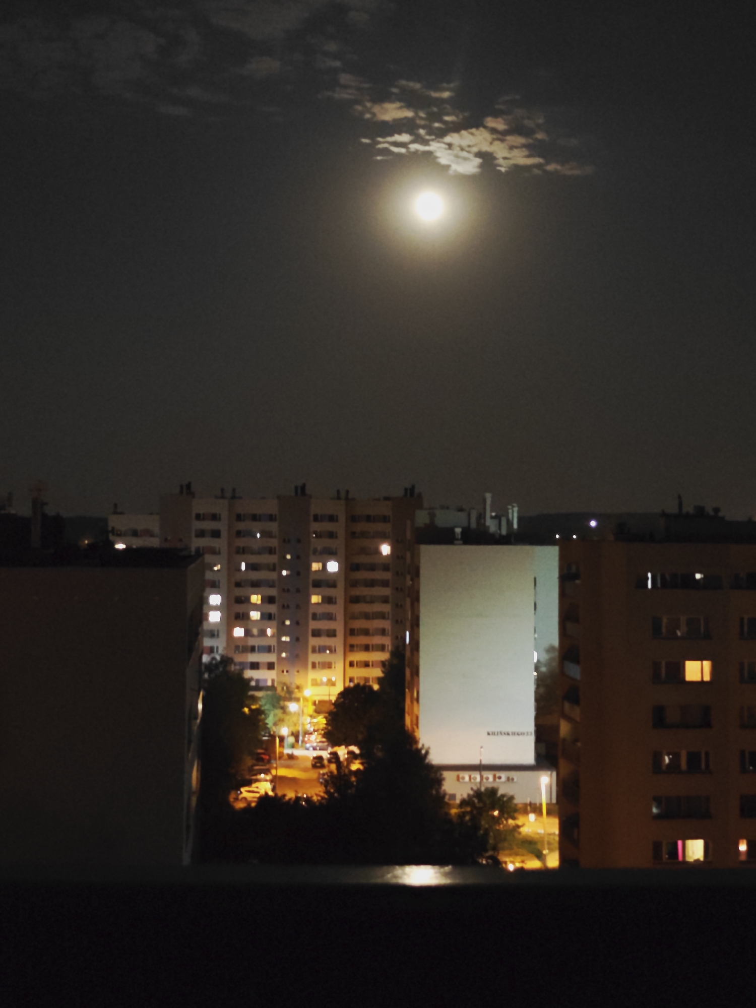 Nighttime apartment views across a quiet urban neighborhood