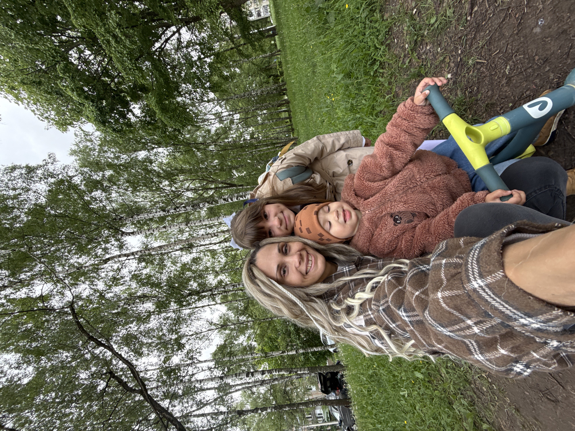 Woman and children enjoy outdoor moment in Rusanovo park
