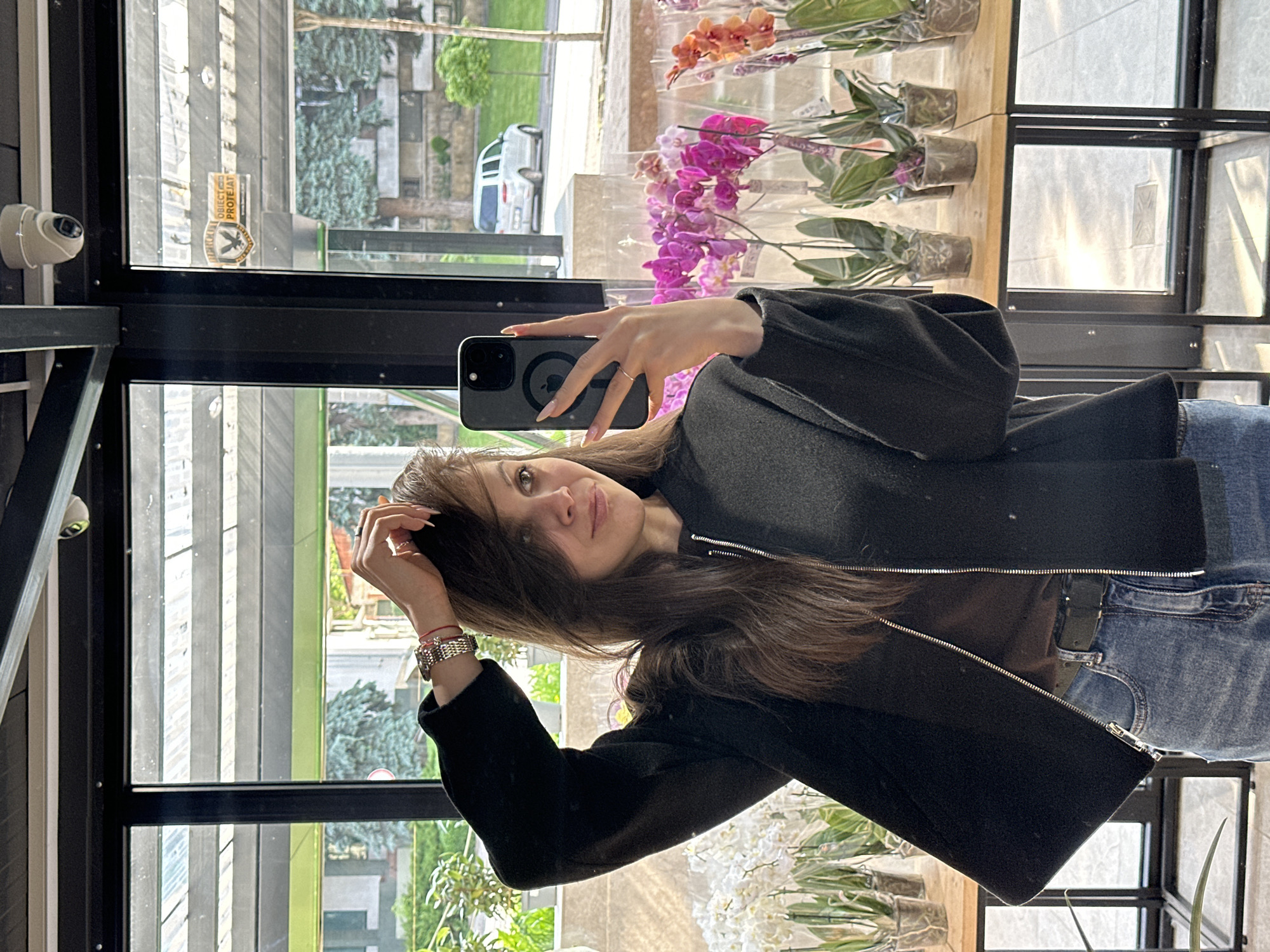 Woman takes selfies during early morning flower shop visit