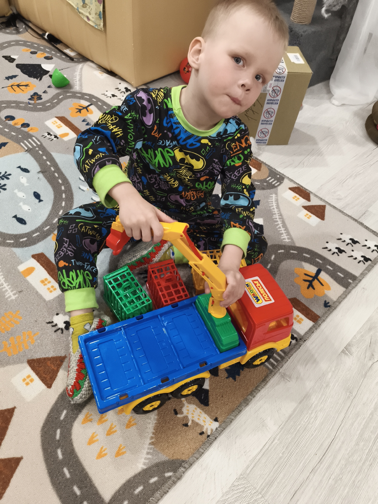Child plays with toy truck in Russian village