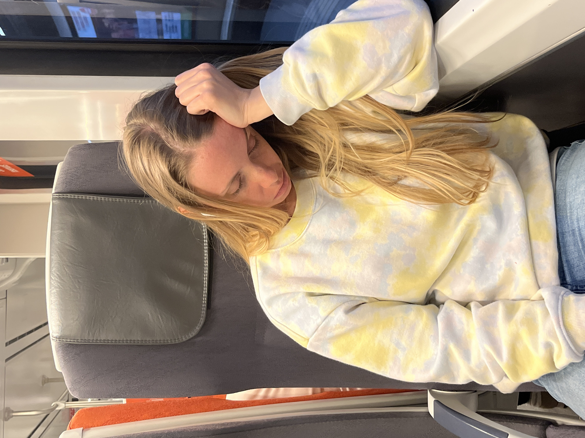Woman sleeps on train in Barcelona