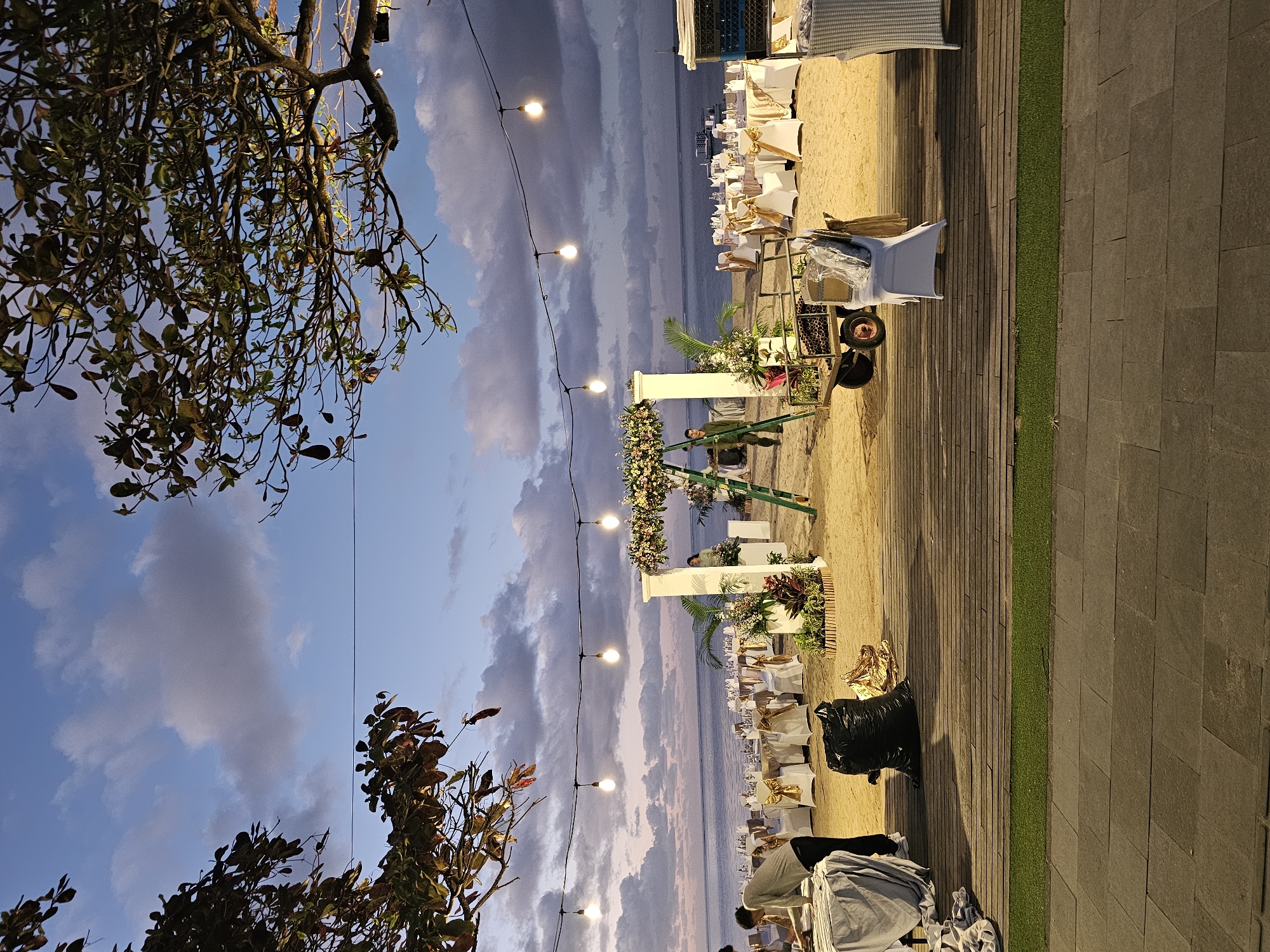 Beach wedding preparations documented at dusk in Denpasar