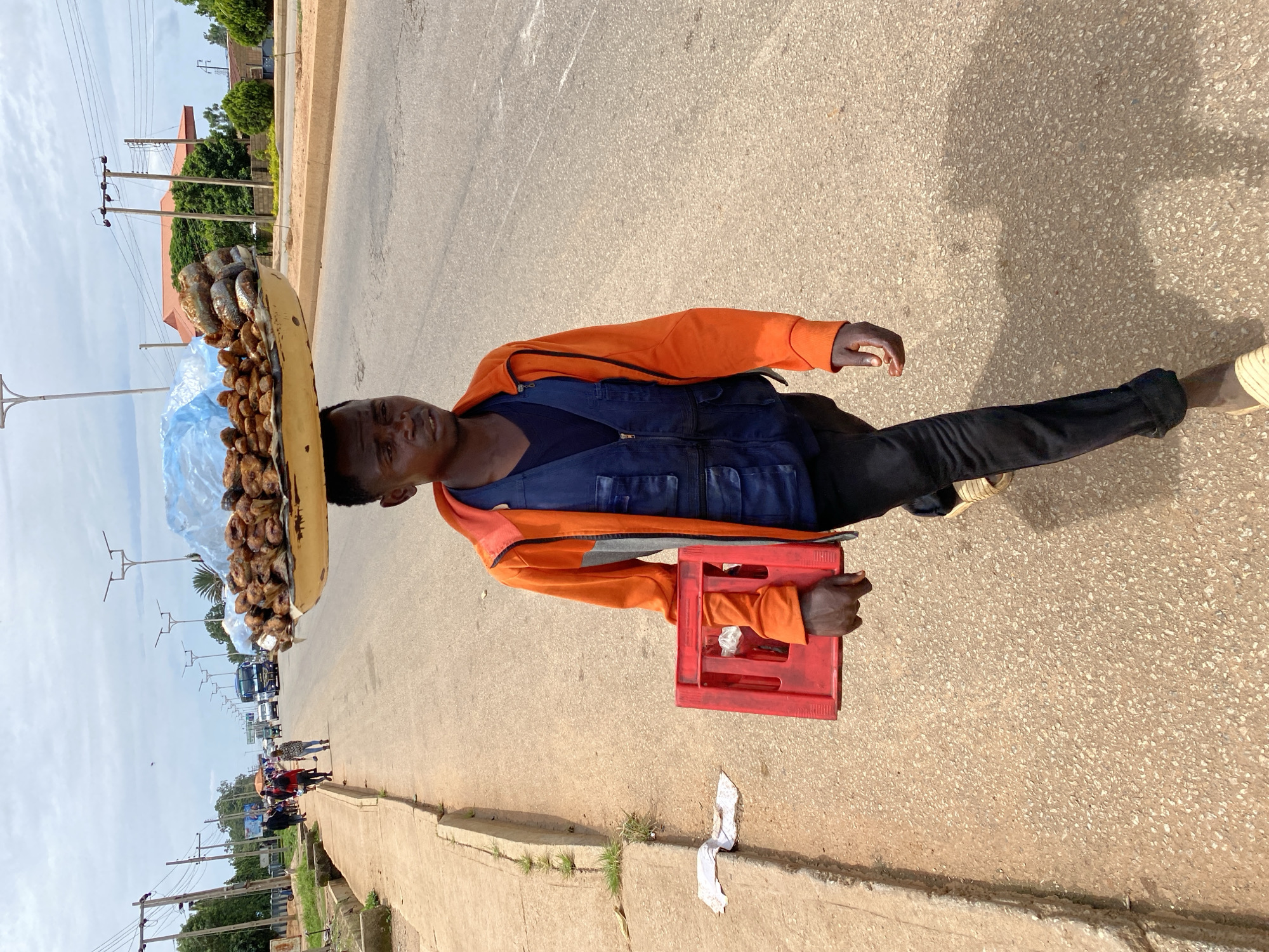 Afternoon foot traffic and street commerce in Bukuru, Nigeria