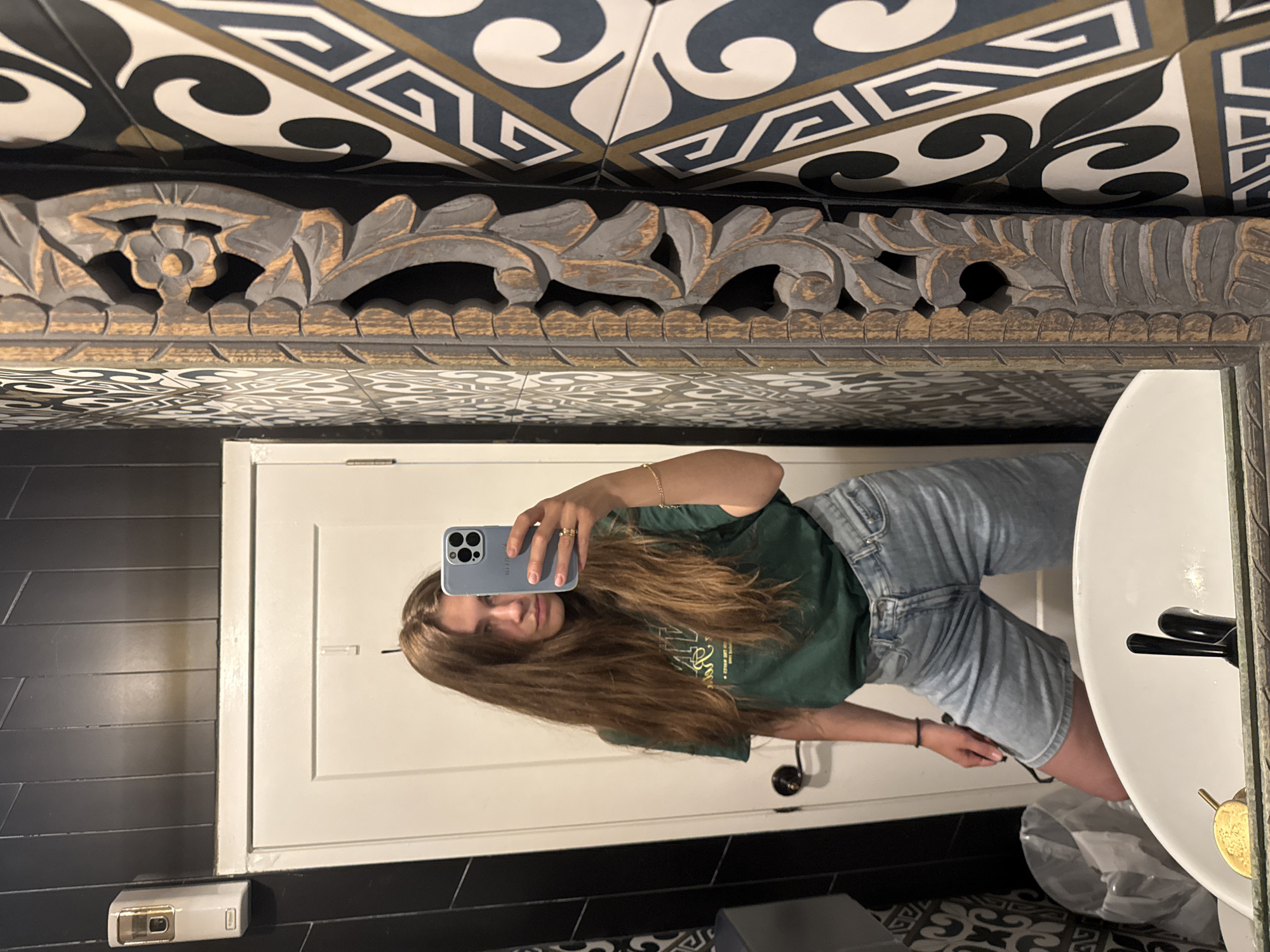 Woman documents Chinatown visit with selfies, archway photos