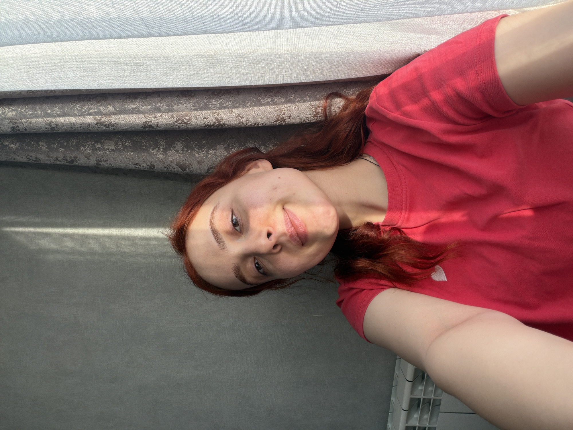 Woman takes selfies in red heart shirt in Tbilisi
