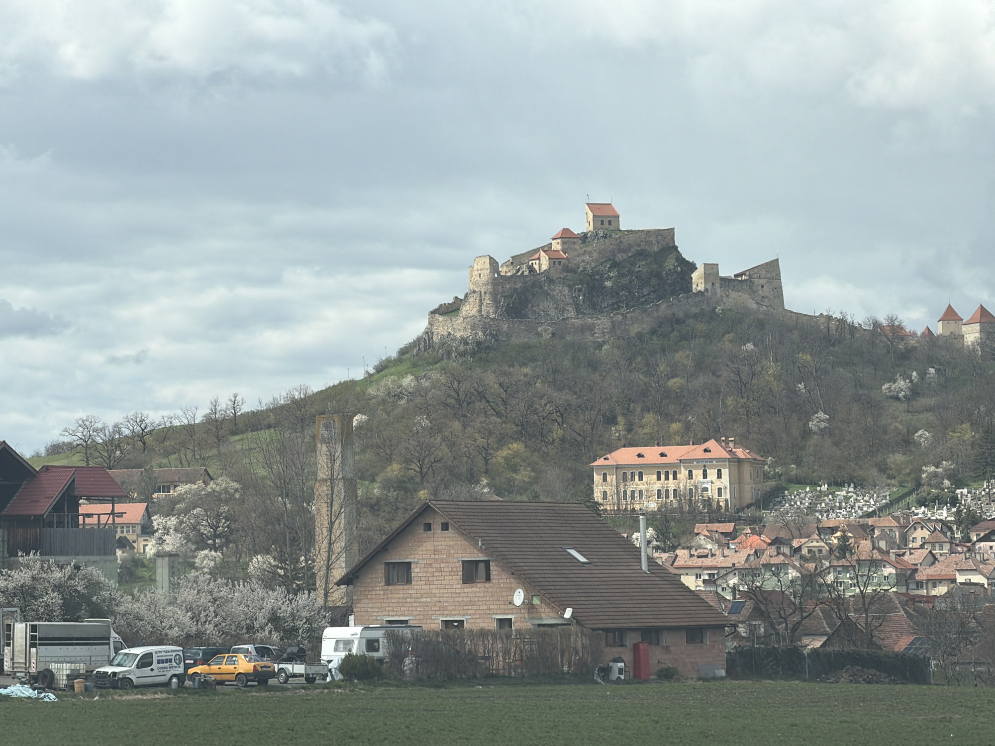 Tourist captures Rupea Fortress views and roadside attraction in Romania