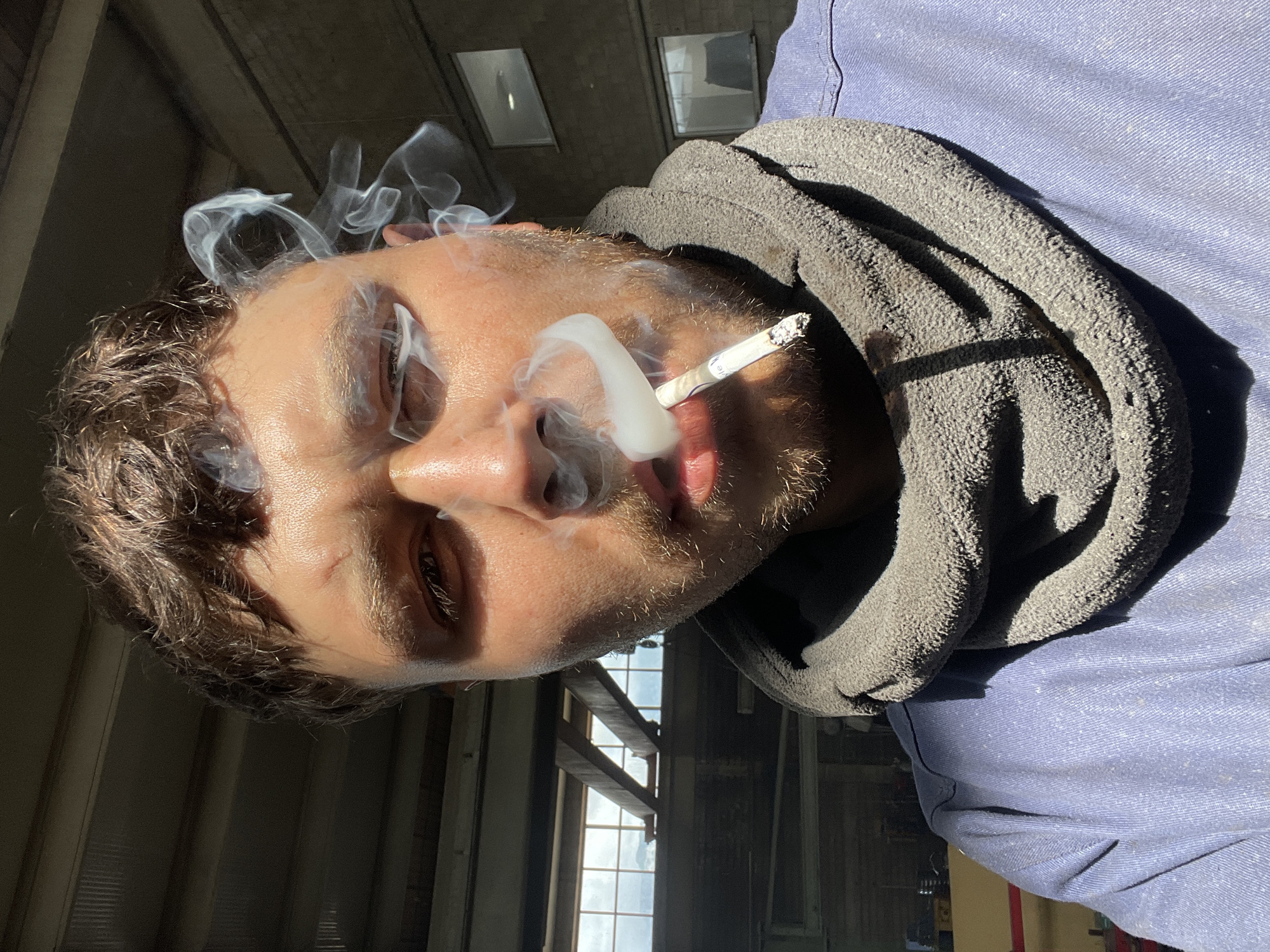 Worker Takes Cigarette Break in Zaljevo, Montenegro