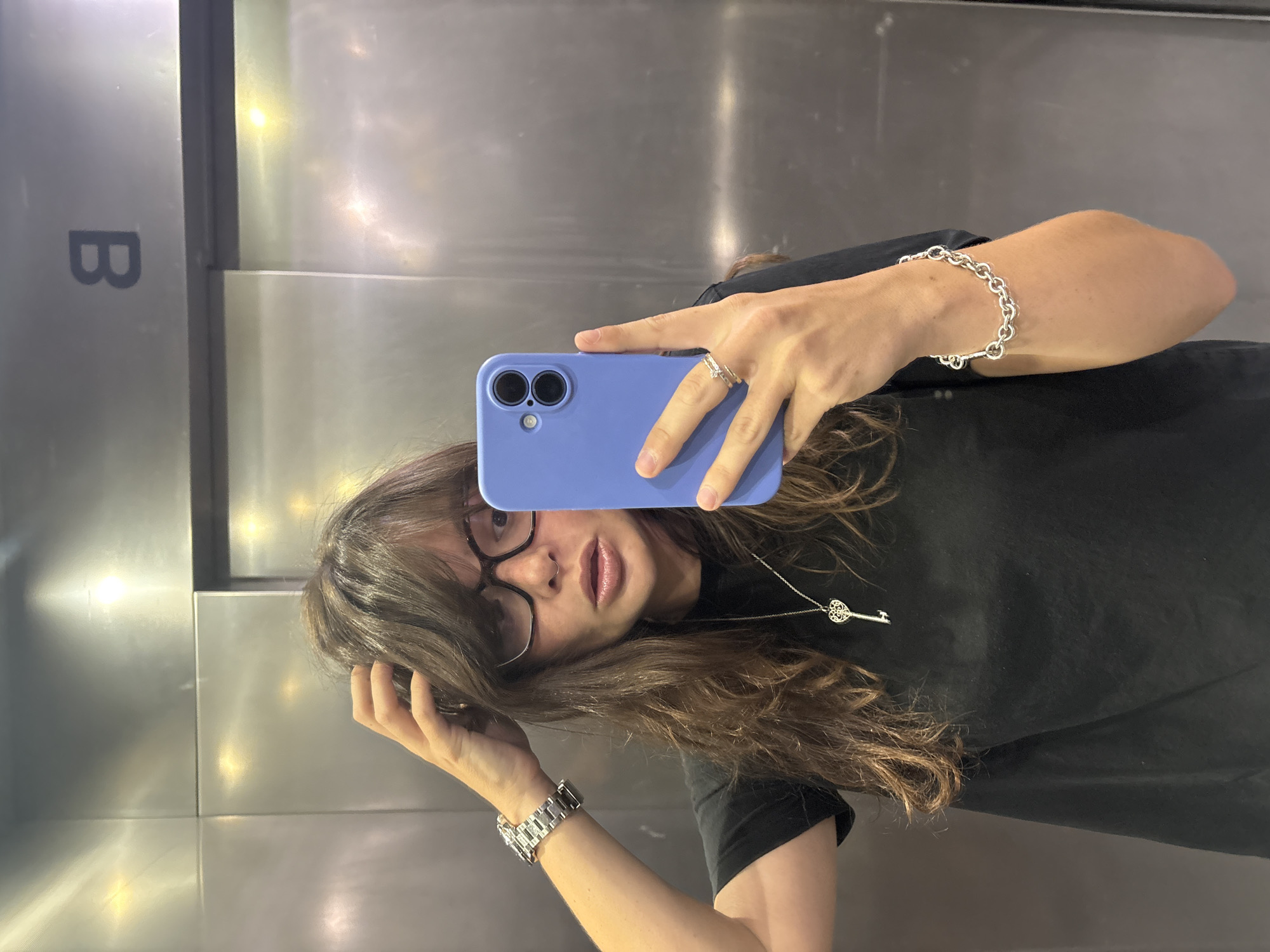 Elevator pause in Tel Aviv with a selfie and iced drink
