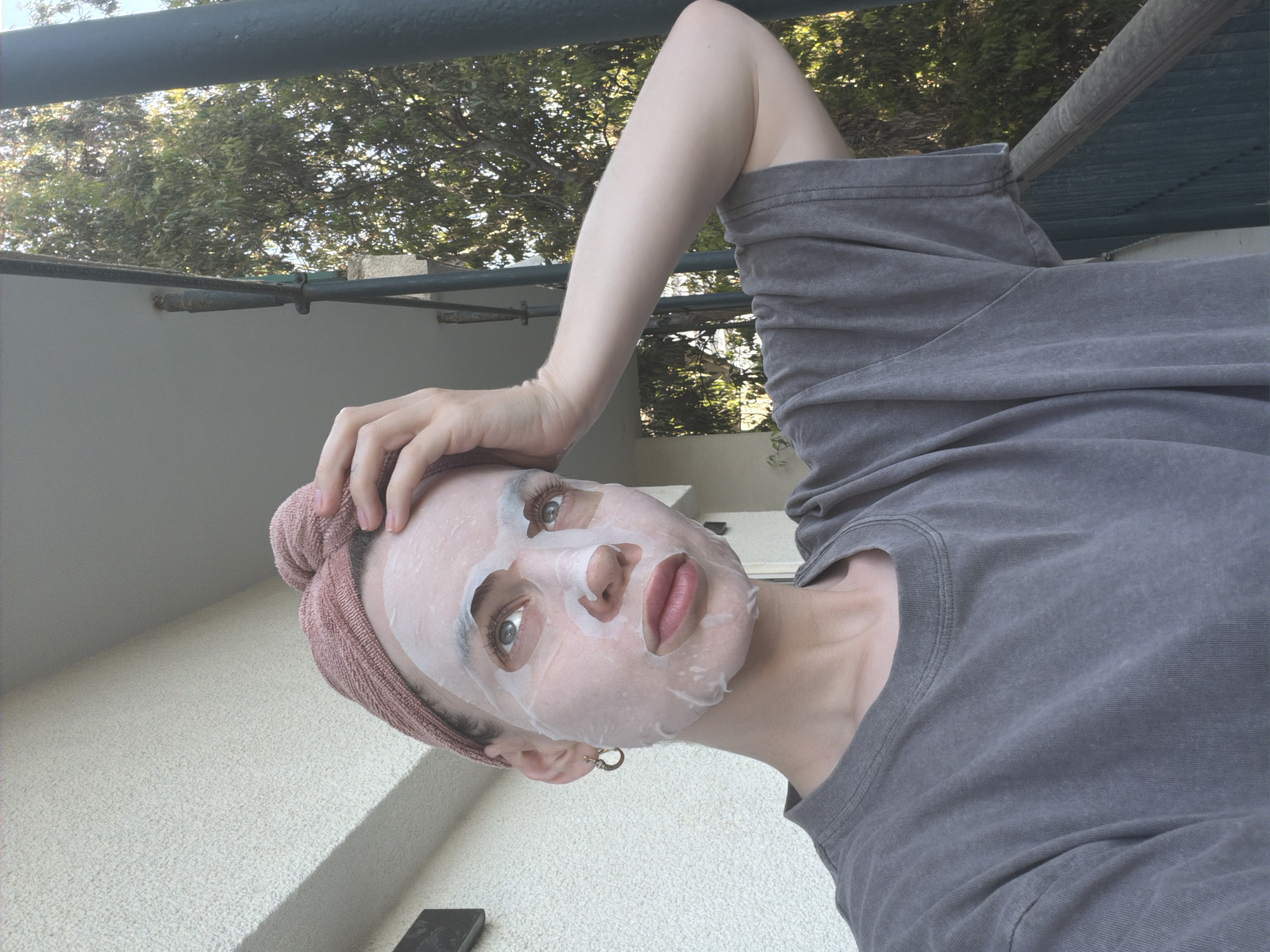 Woman poses for skincare photo in Tel Aviv neighborhood