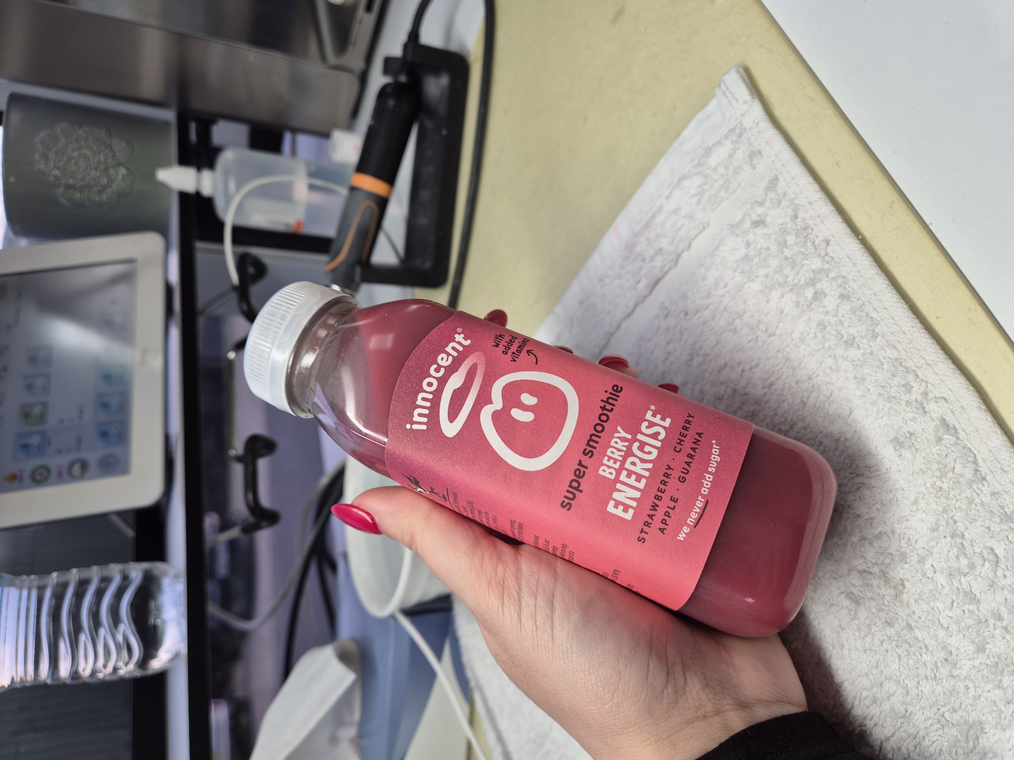 Person opens berry smoothie drink in West Suffolk morning