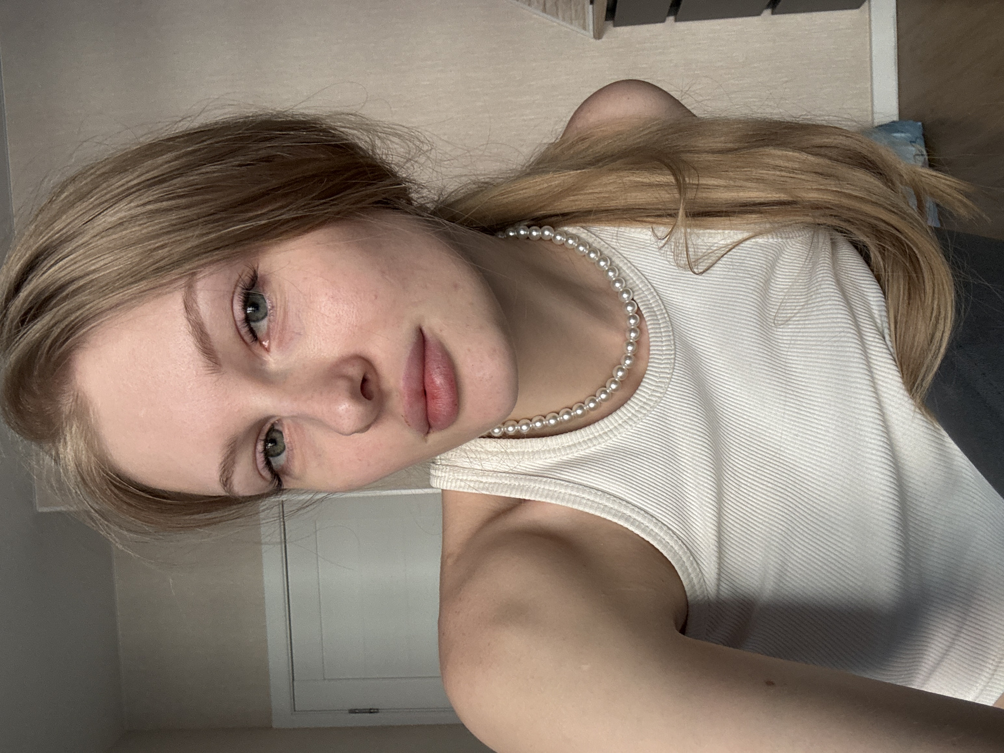 Young woman takes multiple selfies indoors in Perm, Russia