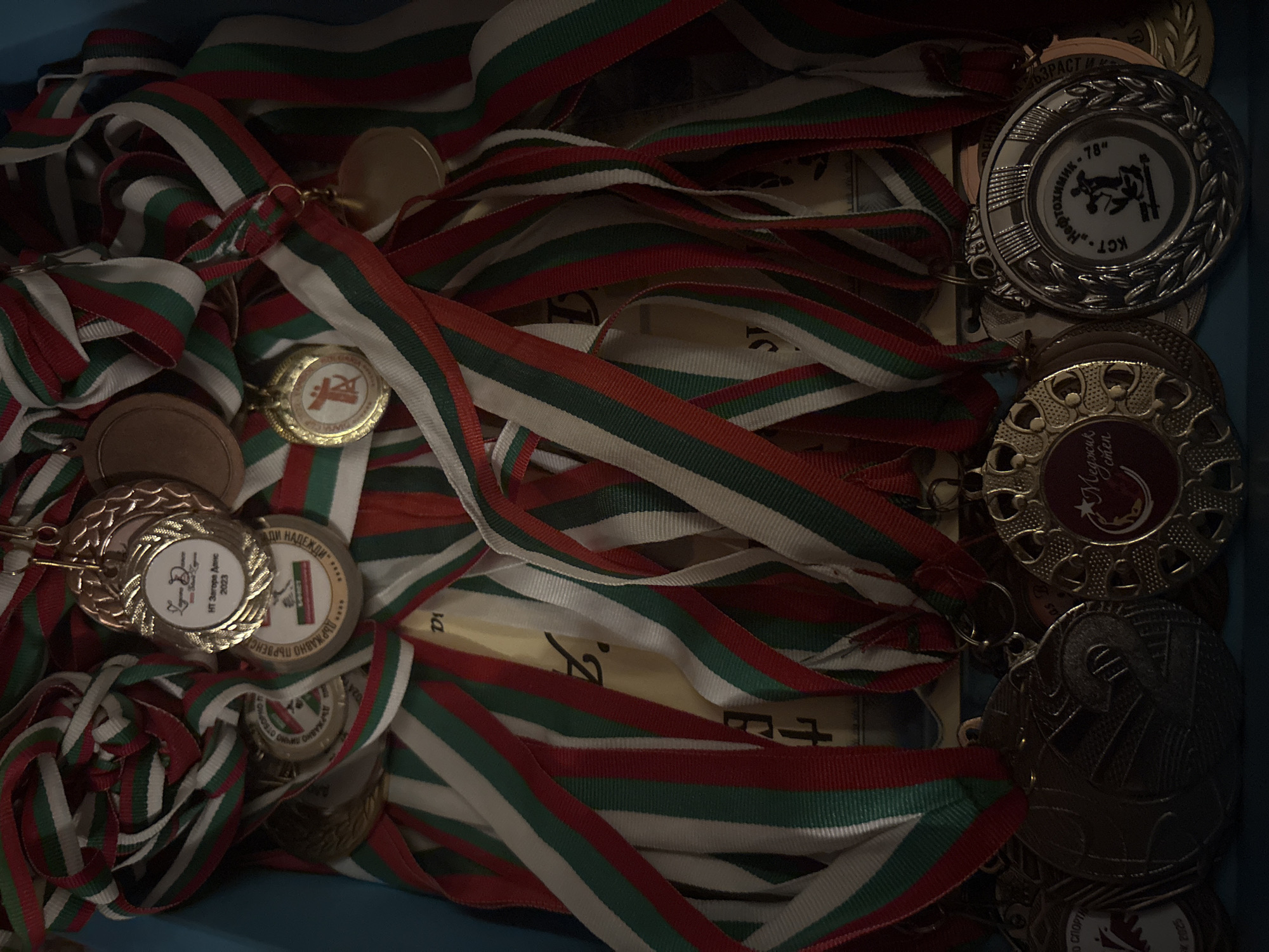 Trophies, medals, and floodlit urban sports fields at night