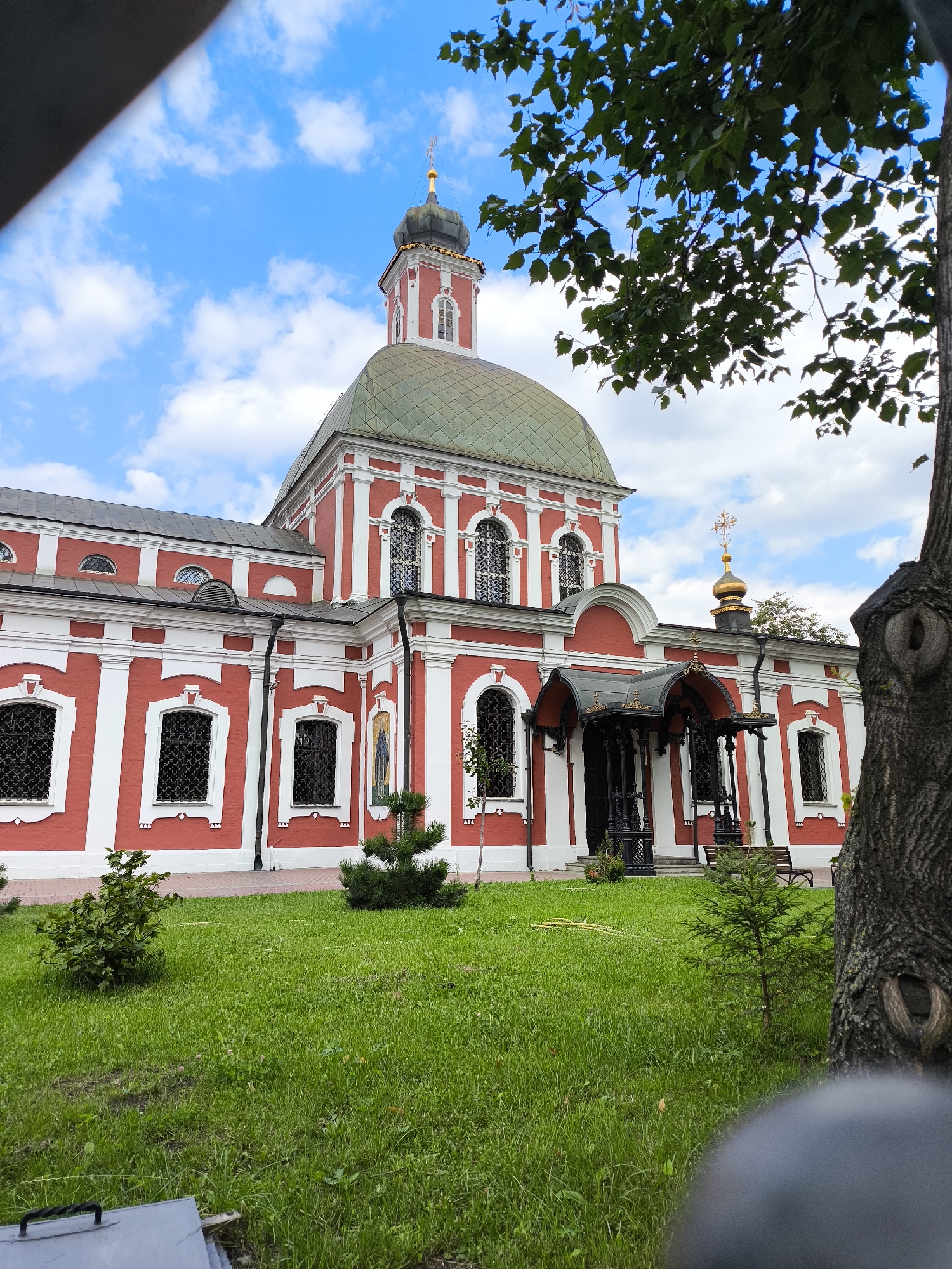 Red Orthodox church exterior explored up close, bell tower and all